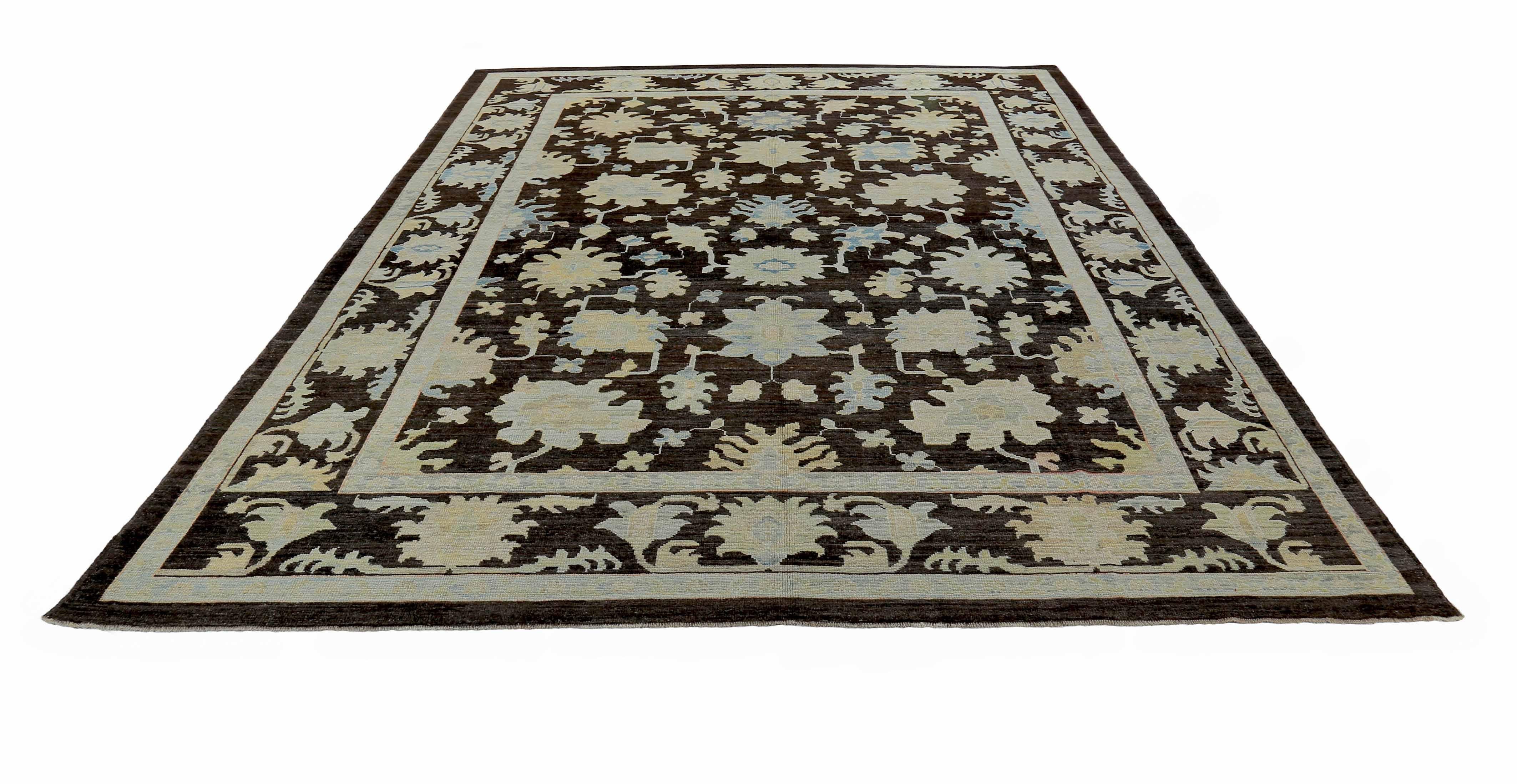 New Turkish rug made of handwoven sheep’s wool of the finest quality. It’s colored with organic vegetable dyes that are certified safe for humans and pets alike. It features blue and beige floral details on a rich dark brown field. Flower patterns