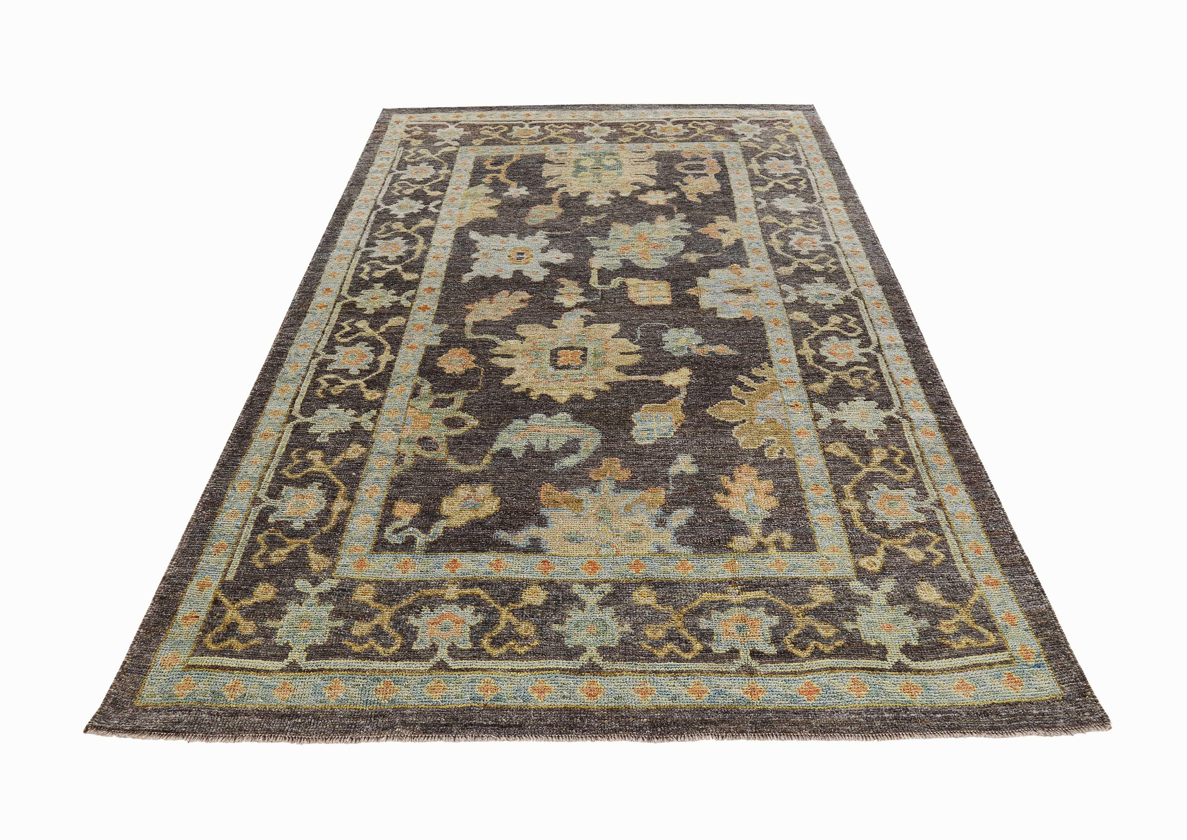 New Turkish rug made of handwoven sheep’s wool of the finest quality. It’s colored with organic vegetable dyes that are certified safe for humans and pets alike. It features blue and beige floral details on a lovely brown field. Flower patterns are