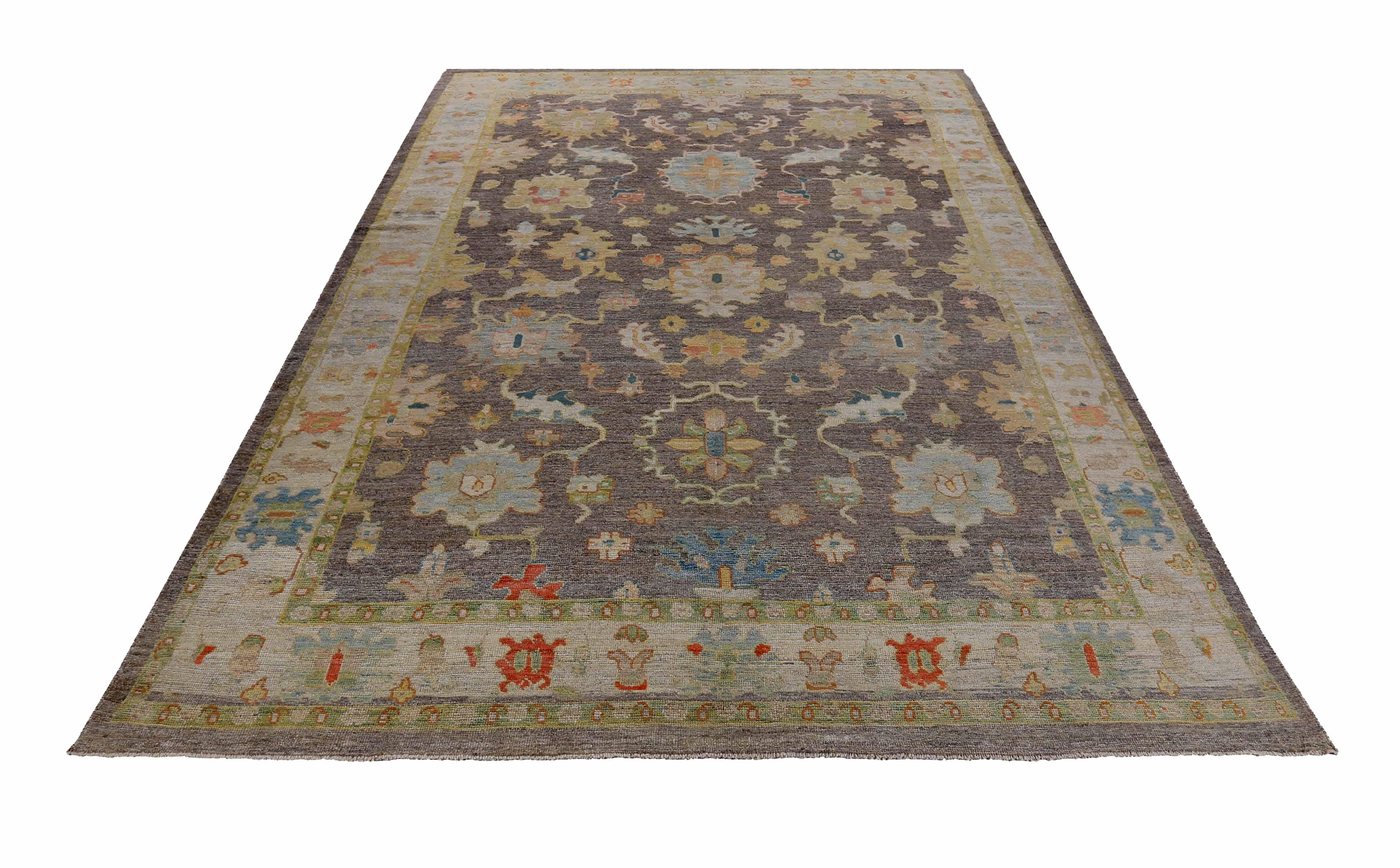 New Turkish rug made of handwoven sheep’s wool of the finest quality. It’s colored with organic vegetable dyes that are certified safe for humans and pets alike. It features green and pink floral details on a lovely brown field. Flower patterns are