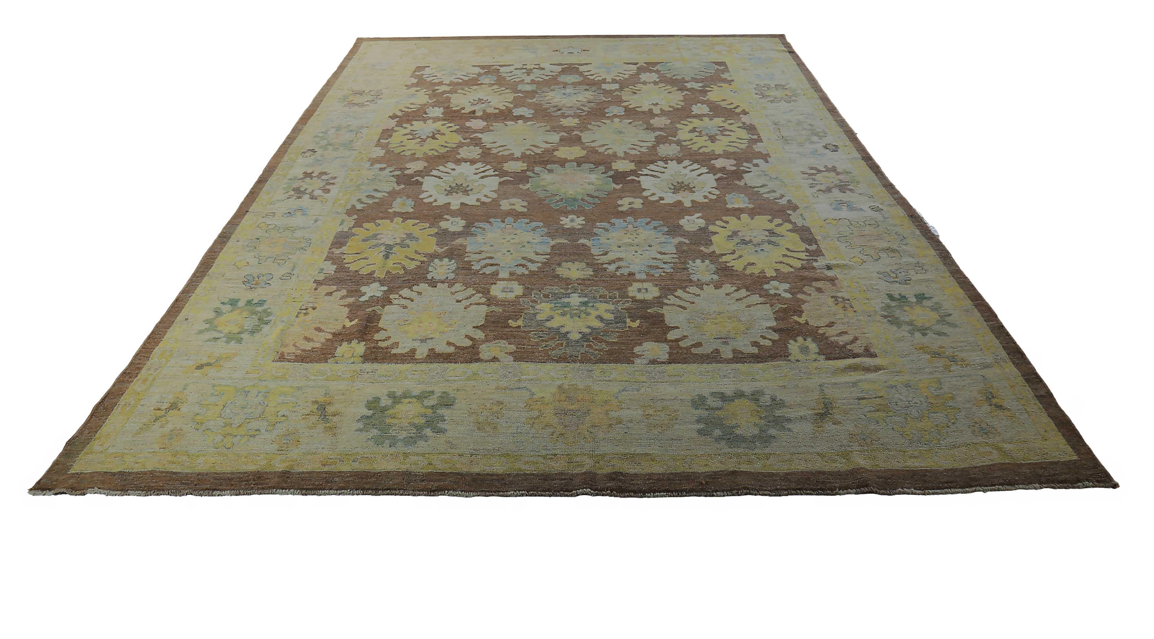 New Turkish rug made of handwoven sheep’s wool of the finest quality. It’s colored with organic vegetable dyes that are certified safe for humans and pets alike. It features blue and beige floral details on a brown field. Flower patterns are
