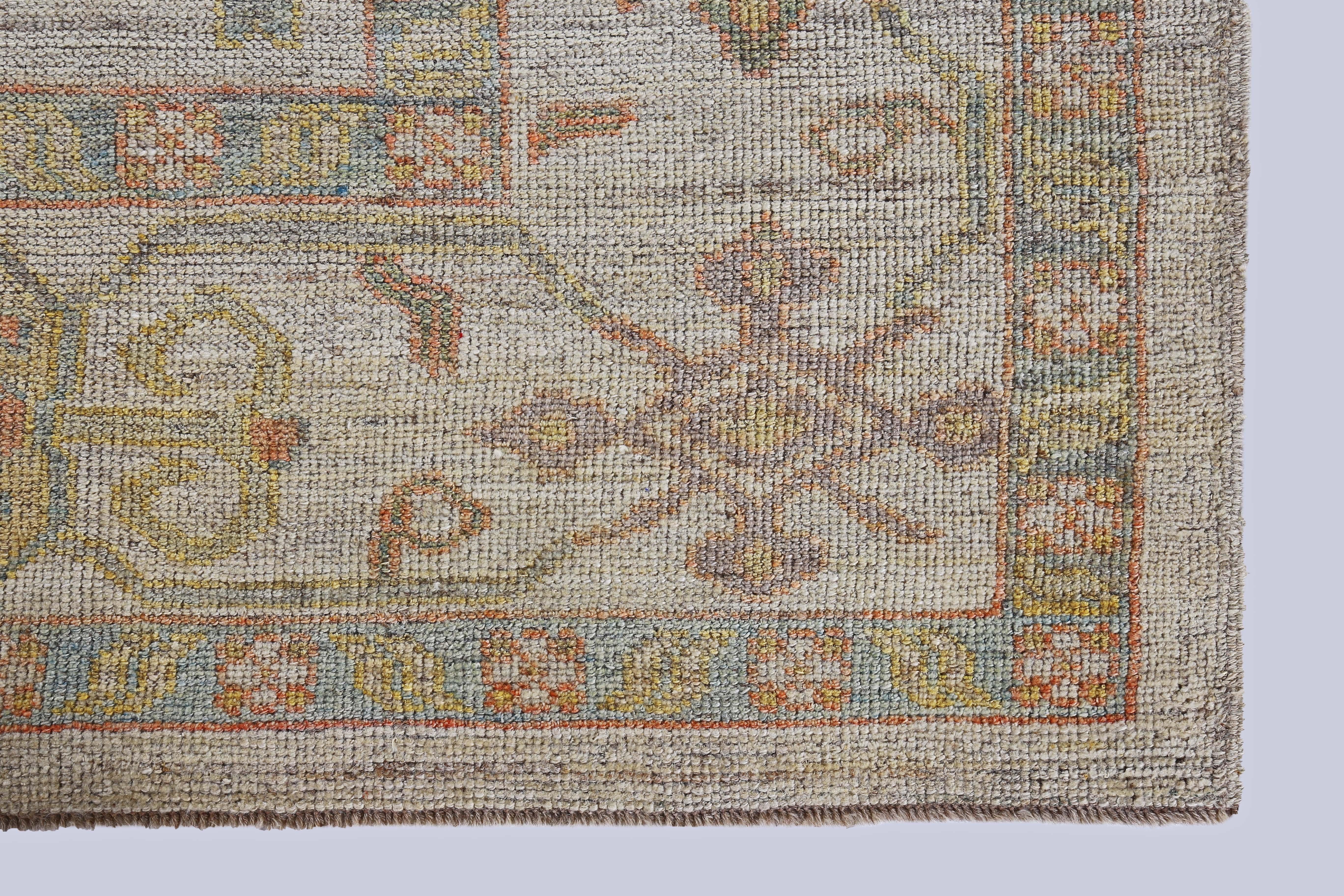 Wool Turkish Oushak Rug with Blue, Orange and Green Flower Heads on Beige Field For Sale