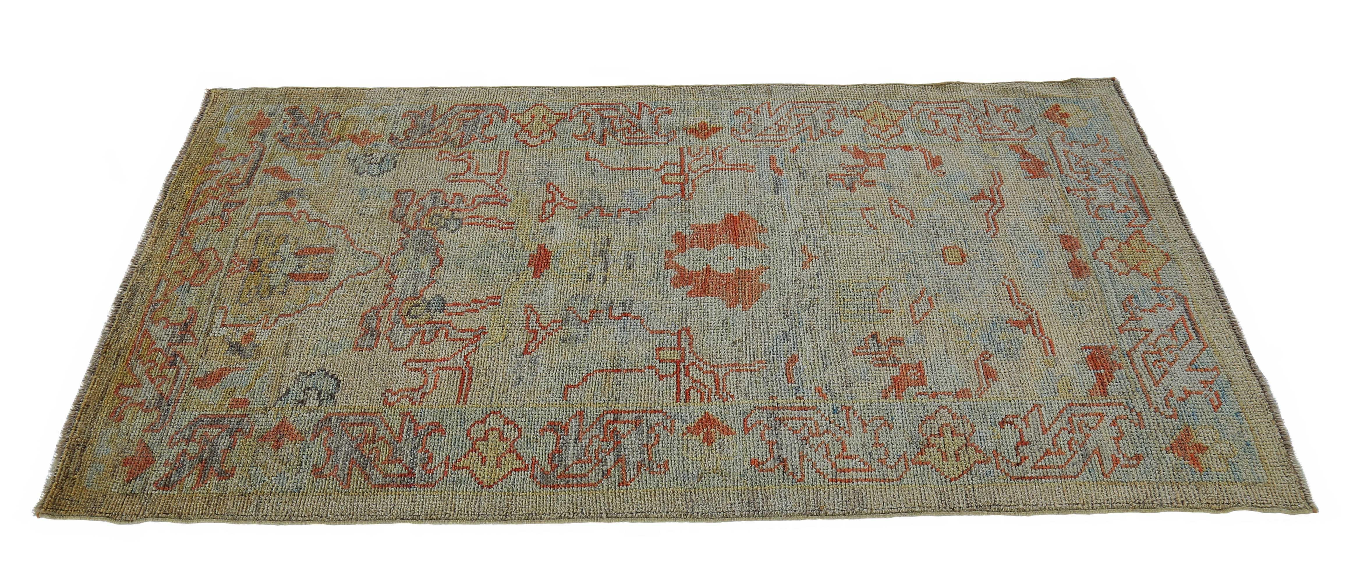 New Turkish rug made of handwoven sheep’s wool of the finest quality. It’s colored with organic vegetable dyes that are certified safe for humans and pets alike. It features blue and rust floral details on an ivory field. Flower patterns are