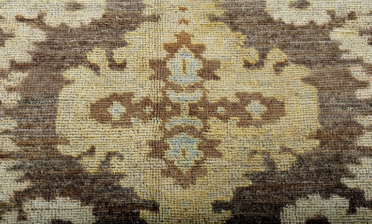 Wool Turkish Oushak Rug with Blue, Yellow and Beige Flower Heads on Brown Field For Sale