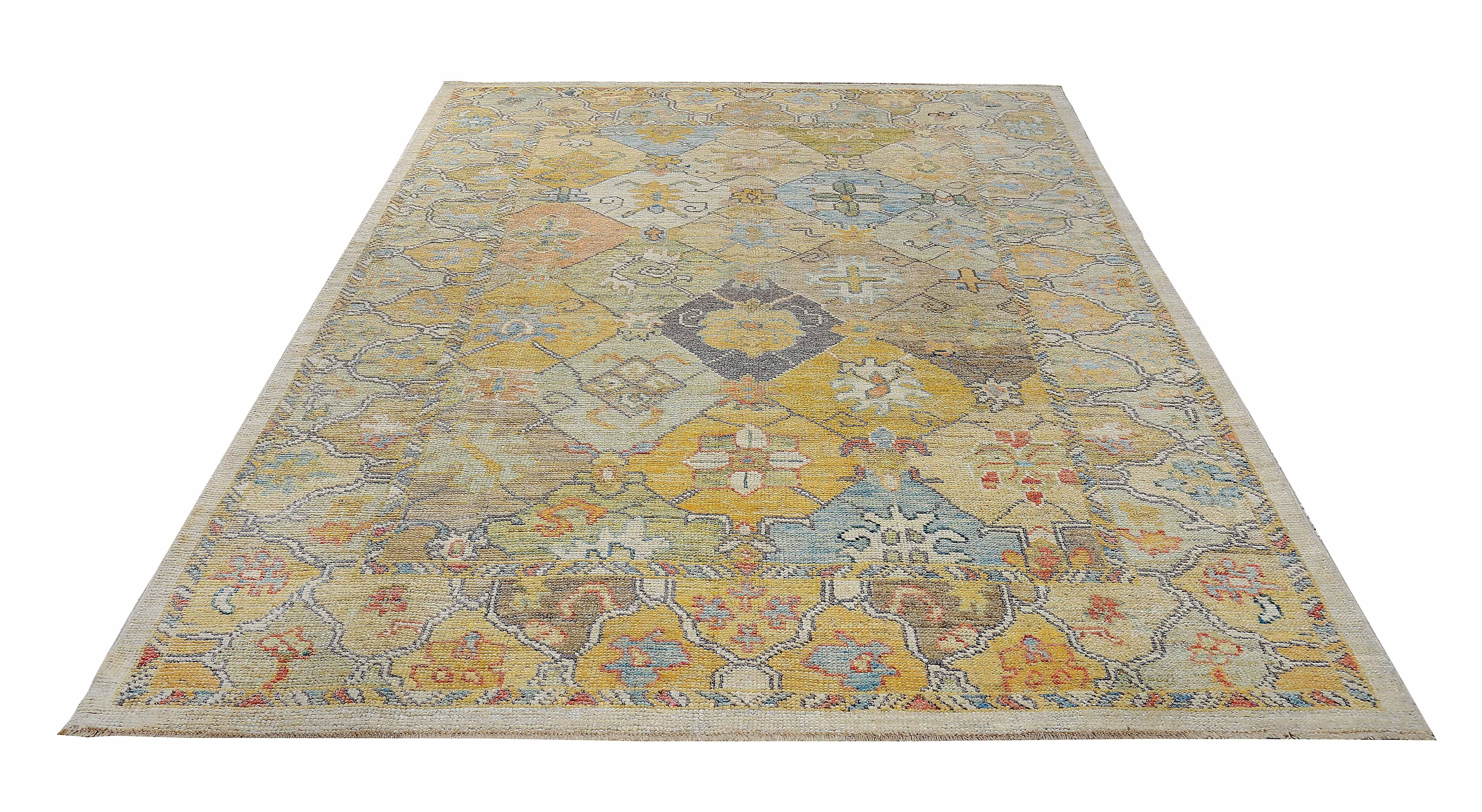 New Turkish rug made of handwoven sheep’s wool of the finest quality. It’s colored with organic vegetable dyes that are certified safe for humans and pets alike. It features blue and yellow floral details on an ivory field. Flower patterns are