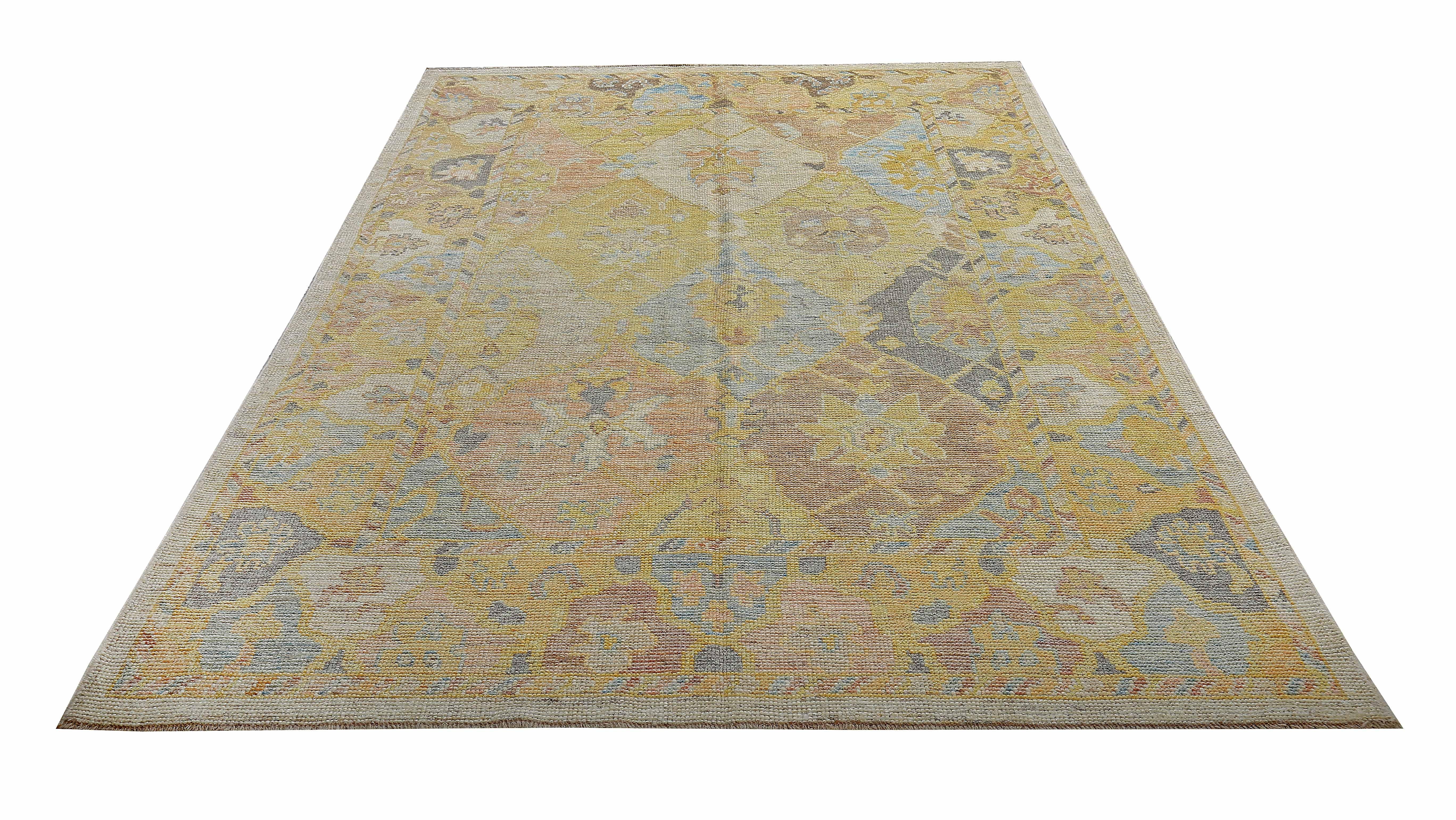 New Turkish rug made of handwoven sheep’s wool of the finest quality. It’s colored with organic vegetable dyes that are certified safe for humans and pets alike. It features brown and gray floral details on an ivory and yellow field. Flower patterns