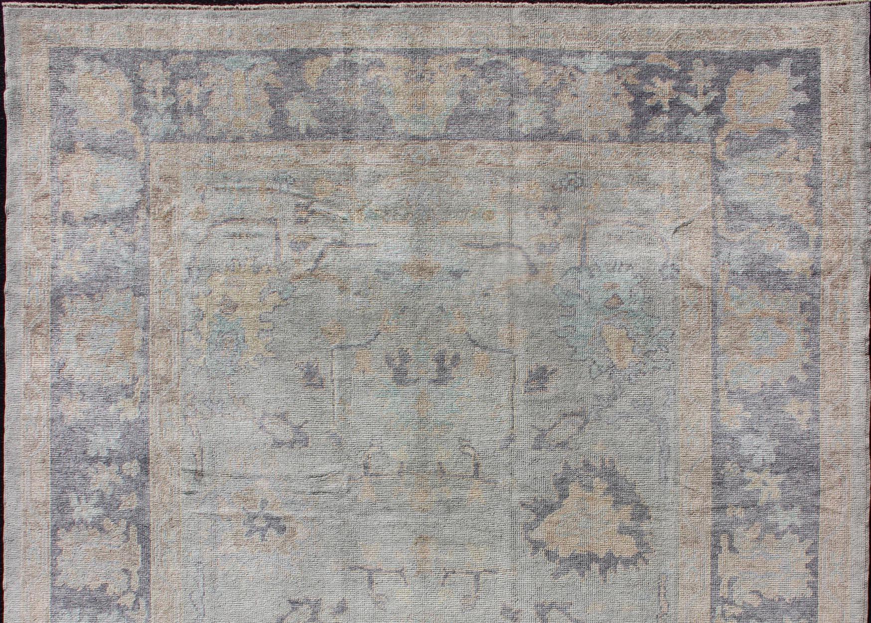 Fine Turkish Oushak rug with gray blue border and neutral color palette and all-over flower design, rug EN-179691, country of origin / type: Turkey / Oushak

This hand Knotted, hand spun Oushak rug from Turkey features a subdued, neutral color