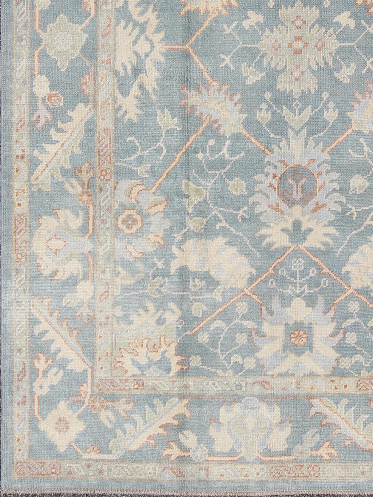 Turkish Oushak with all over design. Early 21st century / rug/ FIT-3277 /Keivan Woven Arts 

Turkish Oushak rug with floral design in light steel blue and coral accent
This piece is made with a combination of old wool and hand spun wool. This rug