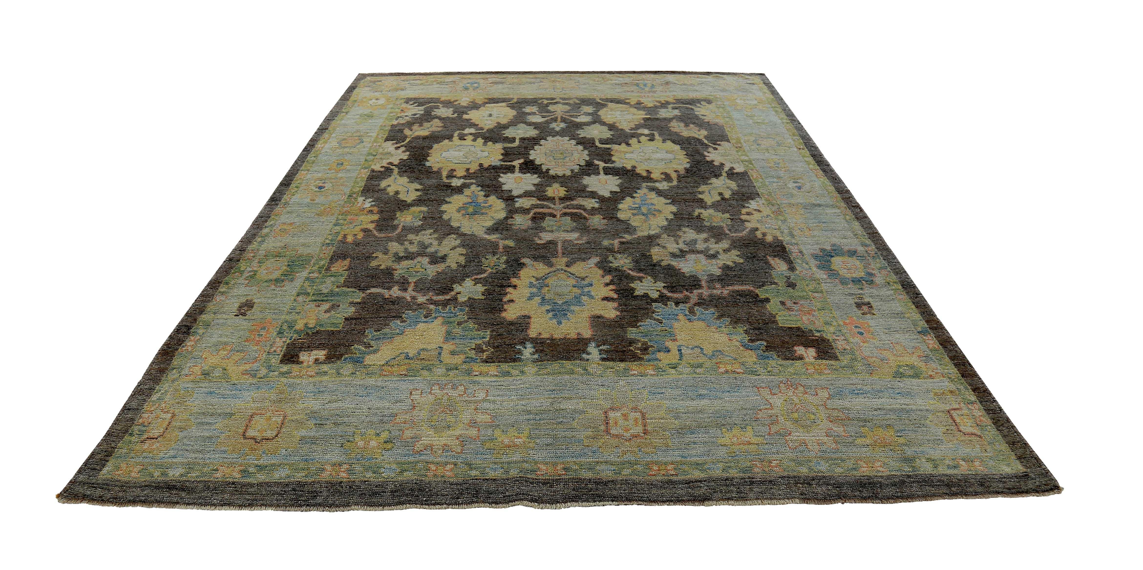 New Turkish rug made of handwoven sheep’s wool of the finest quality. It’s colored with organic vegetable dyes that are certified safe for humans and pets alike. It features gold and blue floral details on a lovely brown and ivory field. Flower
