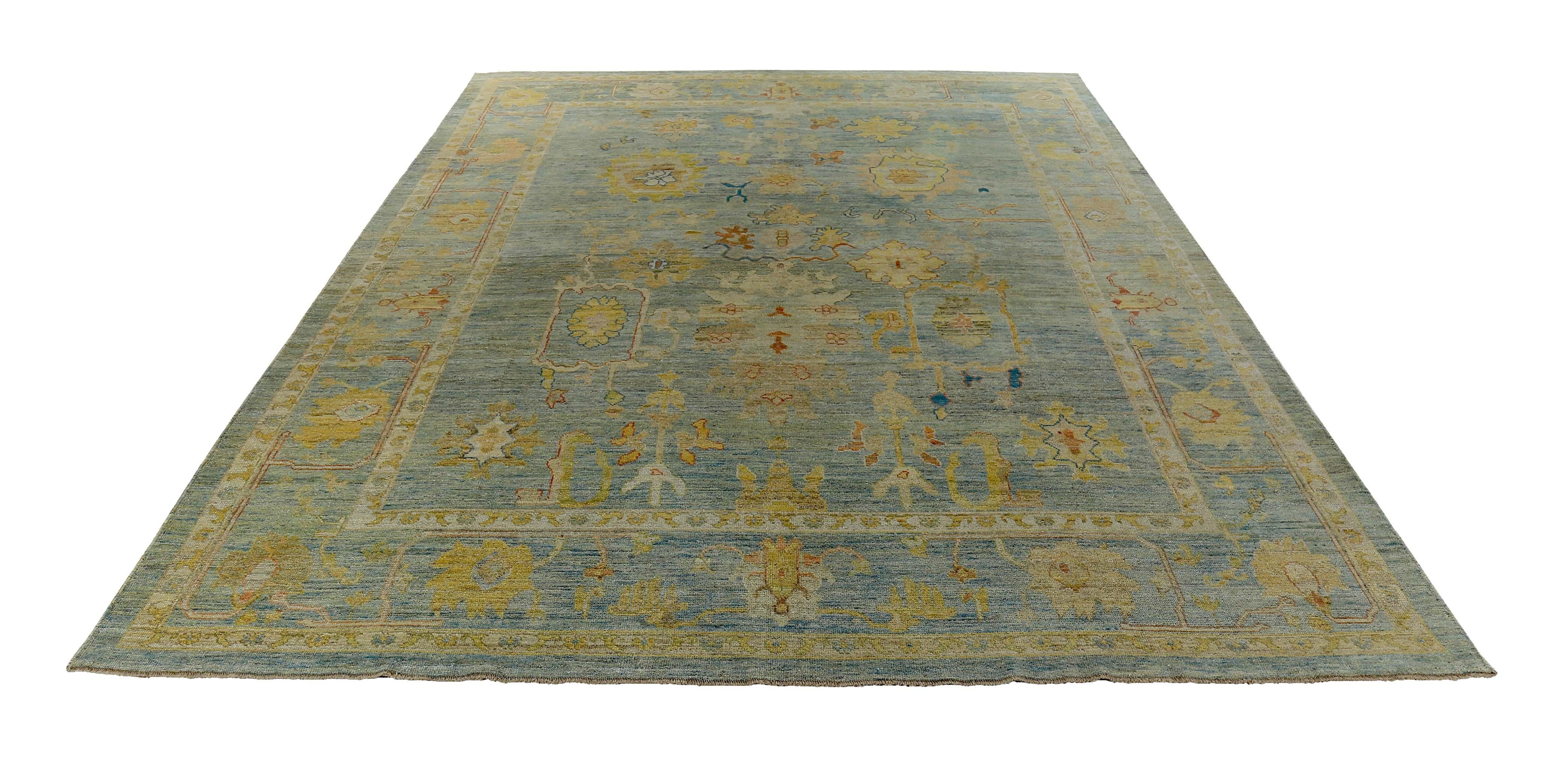 Turkish rug made of handwoven sheep’s wool of the finest quality. It’s colored with organic vegetable dyes that are certified safe for humans and pets alike. It features gold, pink and blue floral details on a lovely ivory and brown field. Flower
