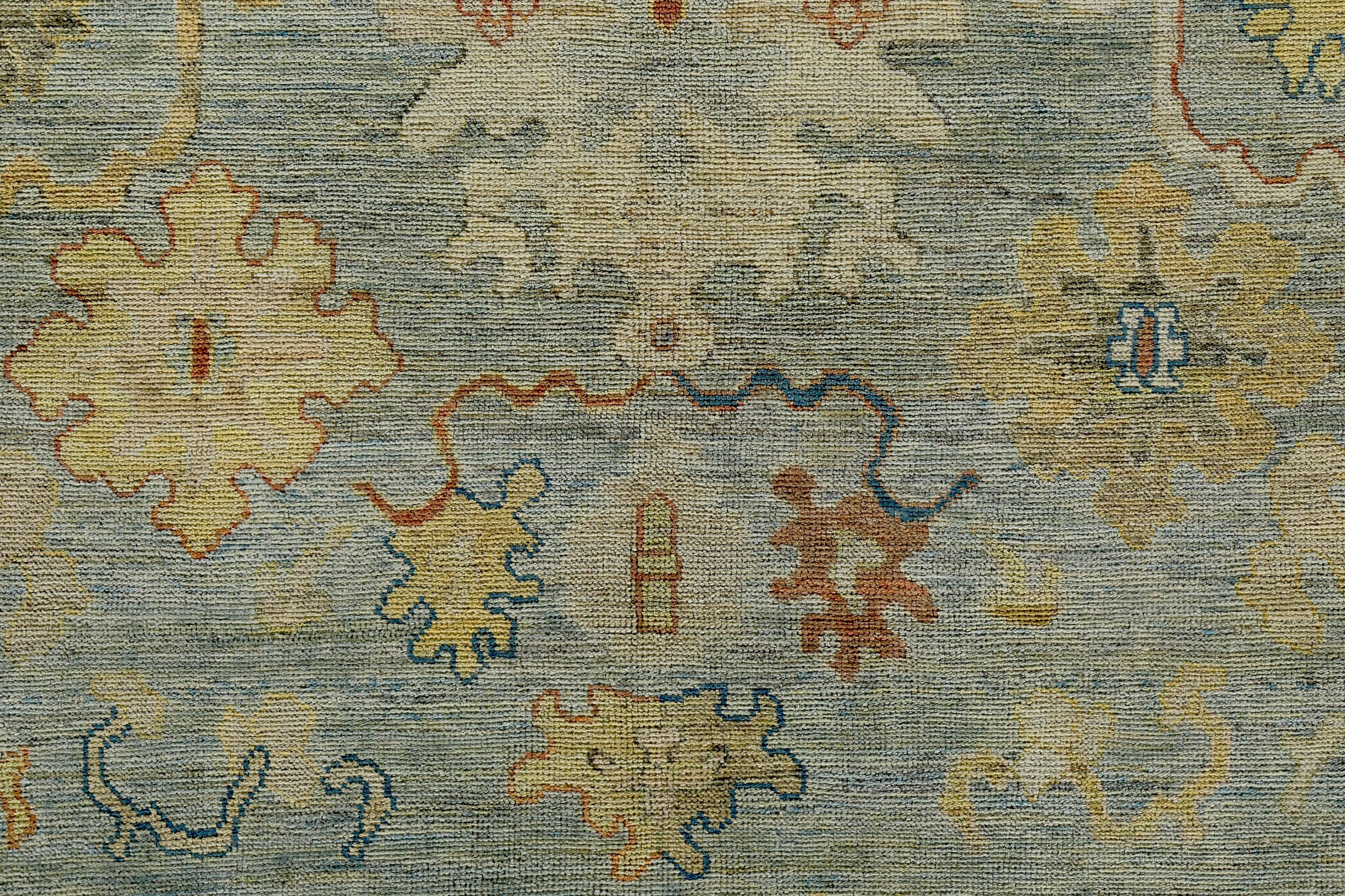 Wool Turkish Oushak Rug with Ivory & Gold Floral Details on Blue Field For Sale