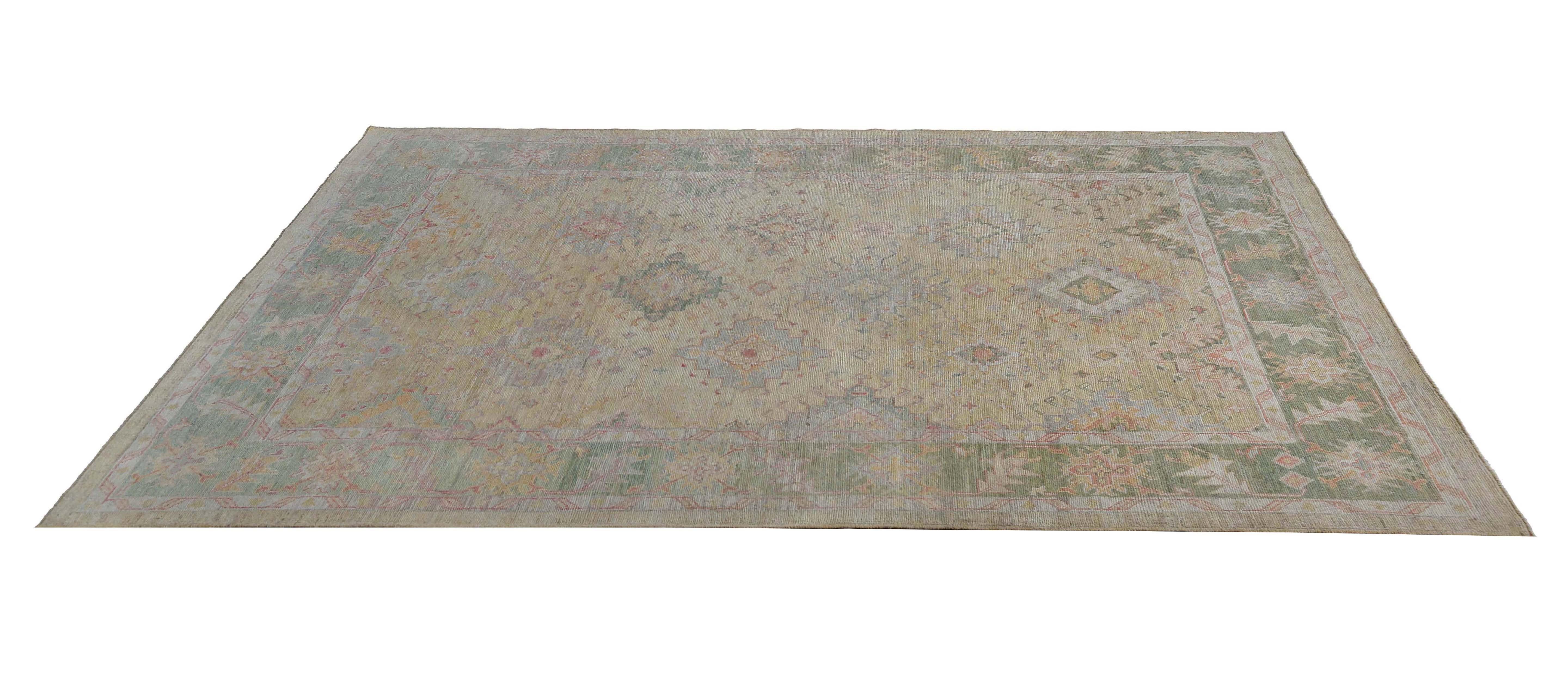 Experience the sheer luxury and timeless elegance of our Turkish Oushak rug, handcrafted to perfection and featuring a mesmerizing design that blends light color tones against a faded background. Measuring 10'2'' x 12'7'', this rug offers ample