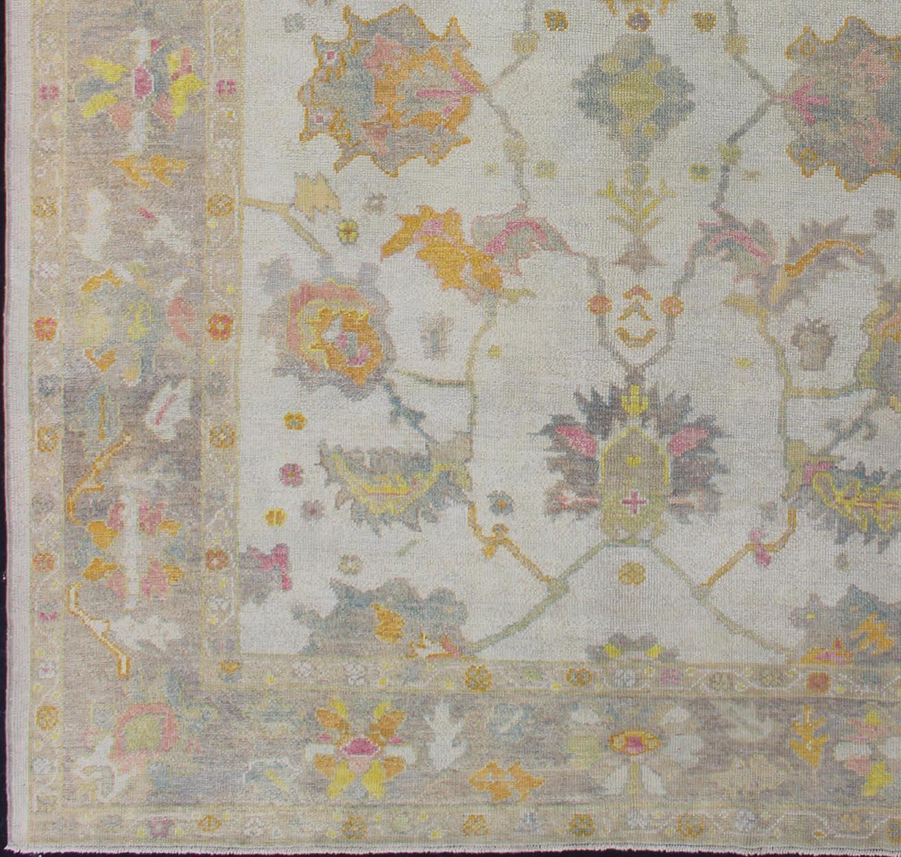 Hand-Knotted Turkish Oushak Rug with Muted Color Palette and All-Over Flower Design For Sale