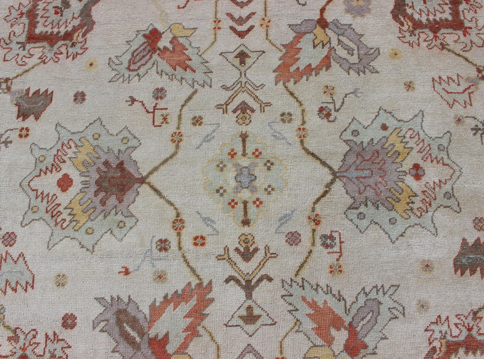 Wool Turkish Oushak Rug with Muted Color Palette and All-Over Flower Design For Sale
