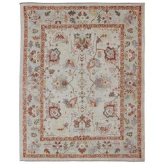 Tapis turc Oushak avec une palette de couleurs sourdes et un motif de fleurs sur l'ensemble du tapis