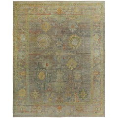 Turkish Oushak Rug with Orange and Gold Floral Details on Brown Field