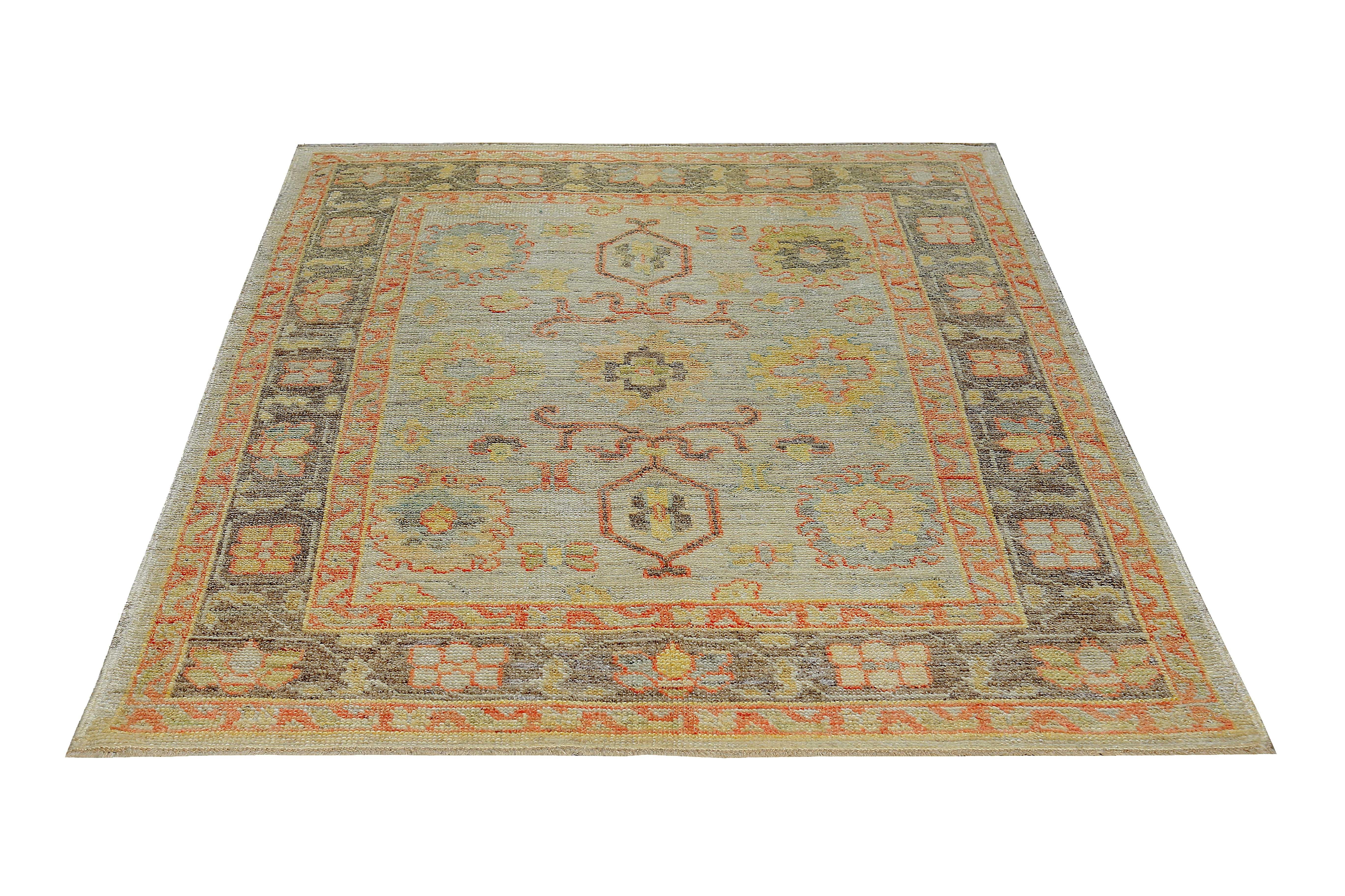 New Turkish rug made of handwoven sheep’s wool of the finest quality. It’s colored with organic vegetable dyes that are certified safe for humans and pets alike. It features orange and yellow floral patterns on a fine ivory field bordered by a rich