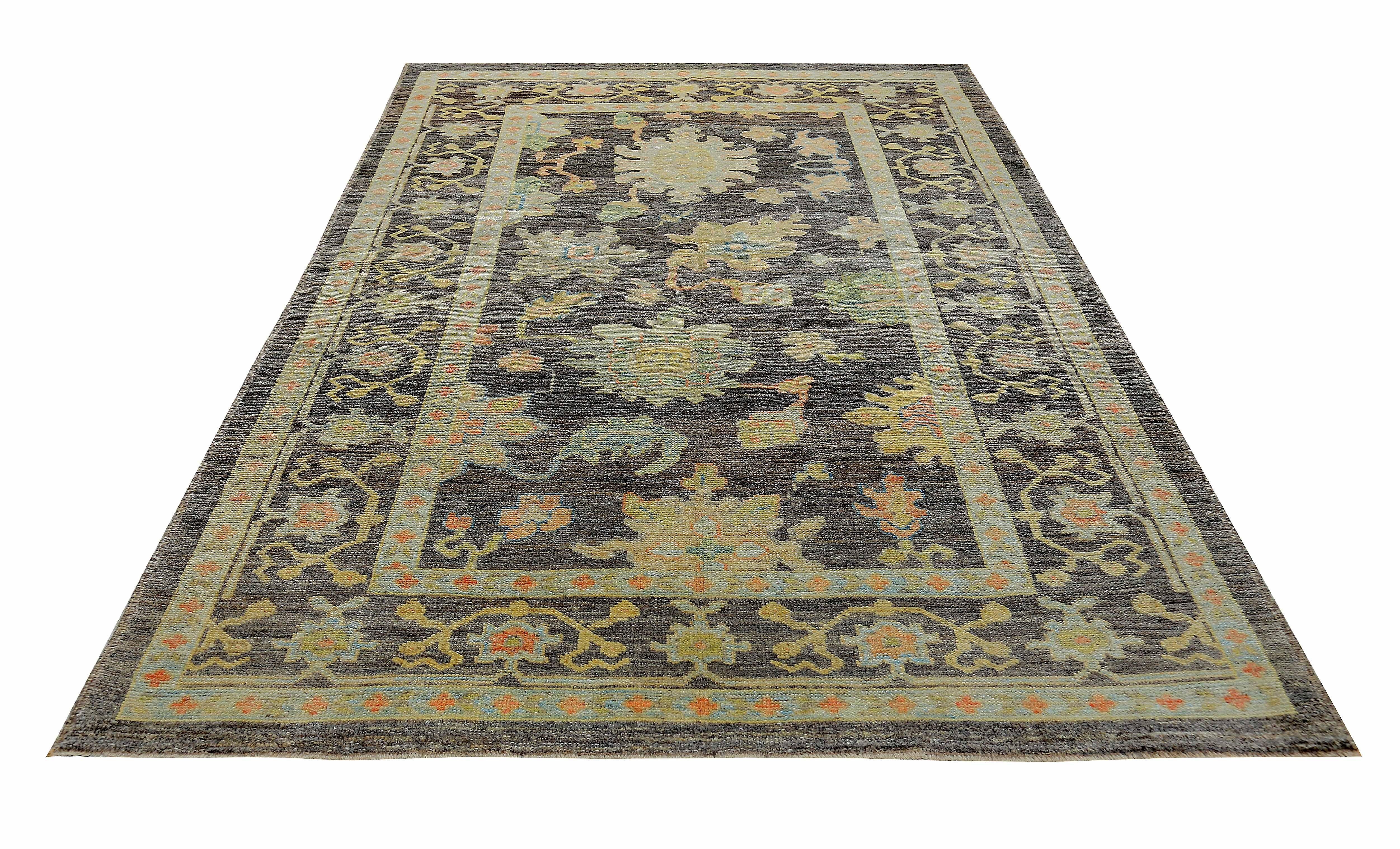 New Turkish rug made of handwoven sheep’s wool of the finest quality. It’s colored with organic vegetable dyes that are certified safe for humans and pets alike. It features pink and gold floral details on a beautiful brown field. Flower patterns