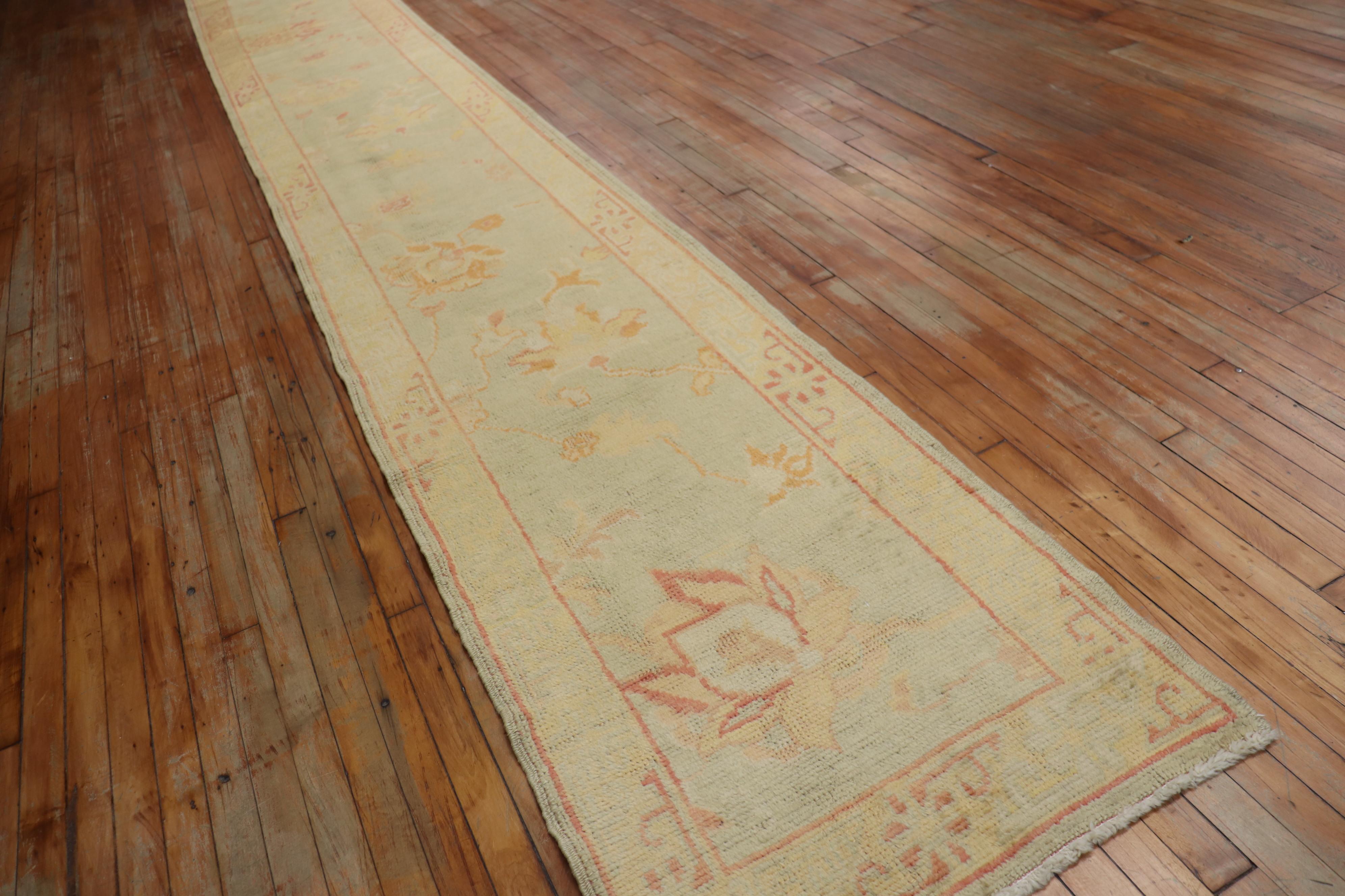 An early 21st century-long and narrow Turkish Oushak runner. Lightfield with other soft casual tones. The rug was made from 100 % vegetable dyed recycled wool used in mid-20th century Turkish Oushak rugs.

Measures: 2'6'' x 21'.