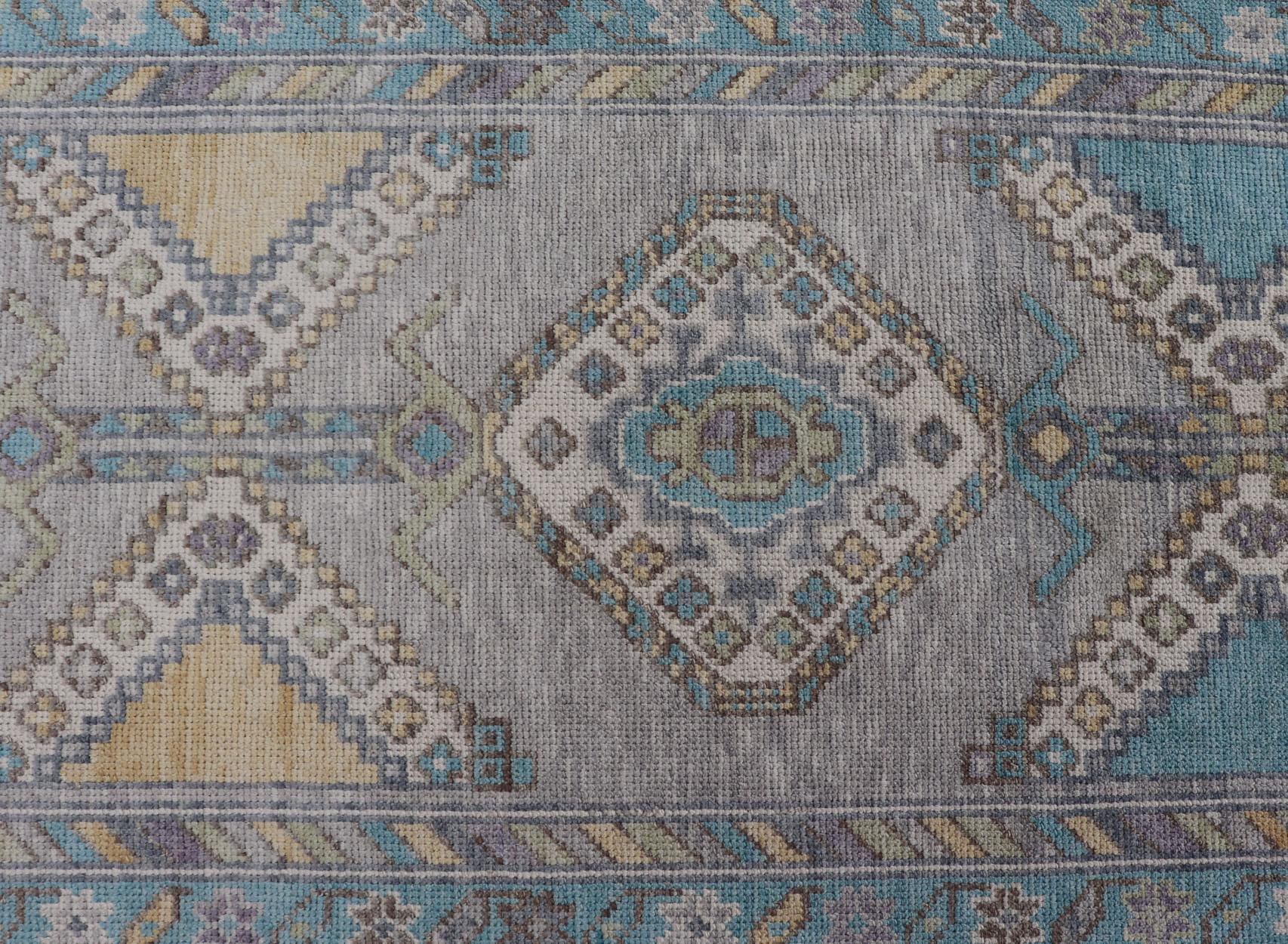Measures: 3'0 x 12'9

Turkish Oushak Runner in Gray with Sky Blue, Ivory, and Gold  3'0 x 12'9. 
Keivan Woven Arts. rug /EN-5006 / Early 21st Century, Turkish Oushak.

This Turkish Oushak runner showcases a bold and balanced geometric design in a
