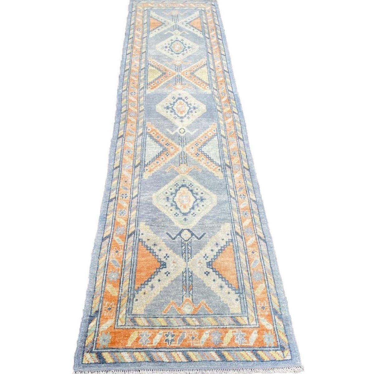 Turkish Oushak runners: Artistic narratives in narrow spaces. These intricate, elongated rugs feature Anatolian charm and vibrant patterns, adding cultural richness and style to hallways and entryways

Exact Size: 2'11