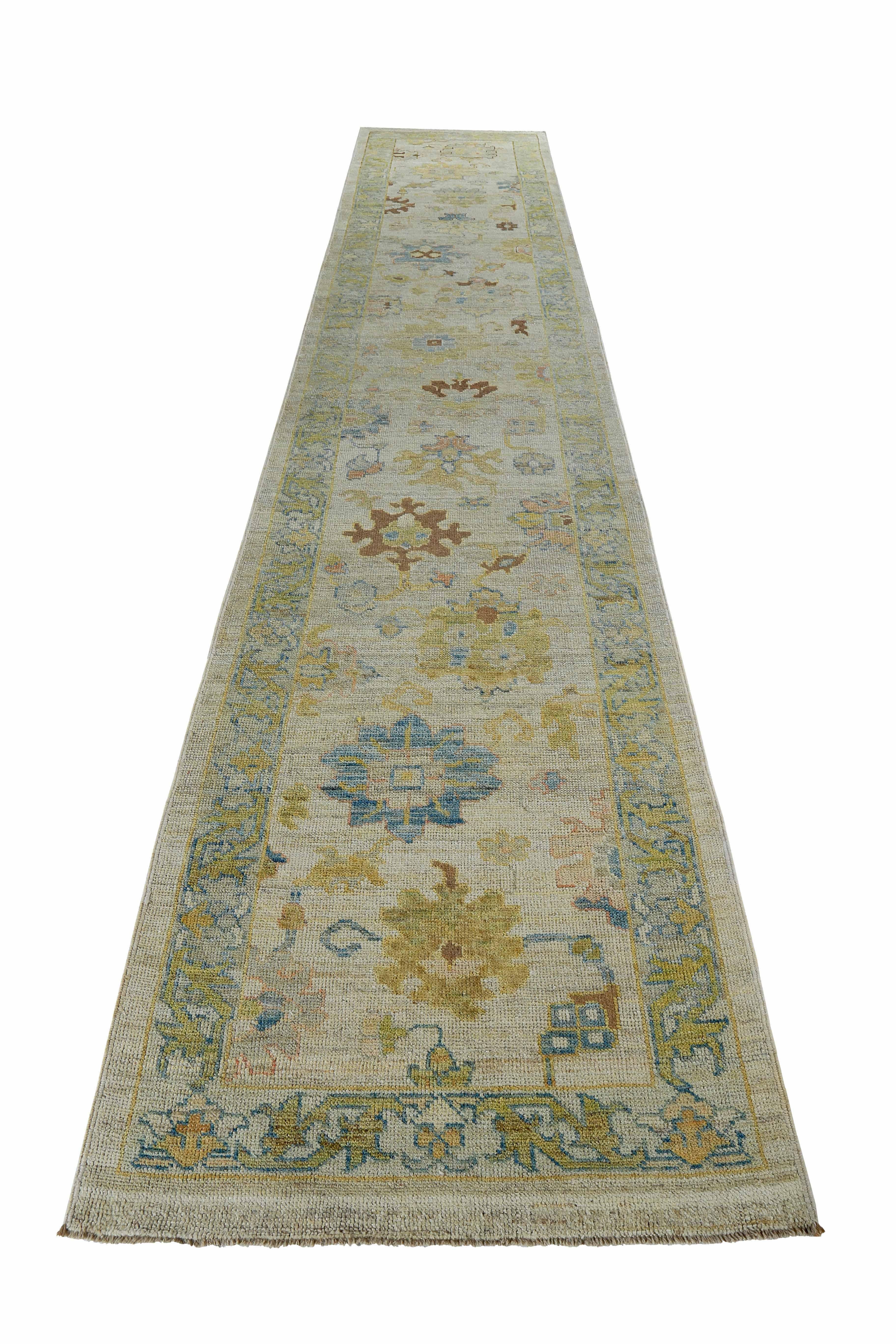 New Turkish runner rug made of handwoven sheep’s wool of the finest quality. It’s colored with organic vegetable dyes that are certified safe for humans and pets alike. It features blue and green floral details on an ivory field. Flower patterns are