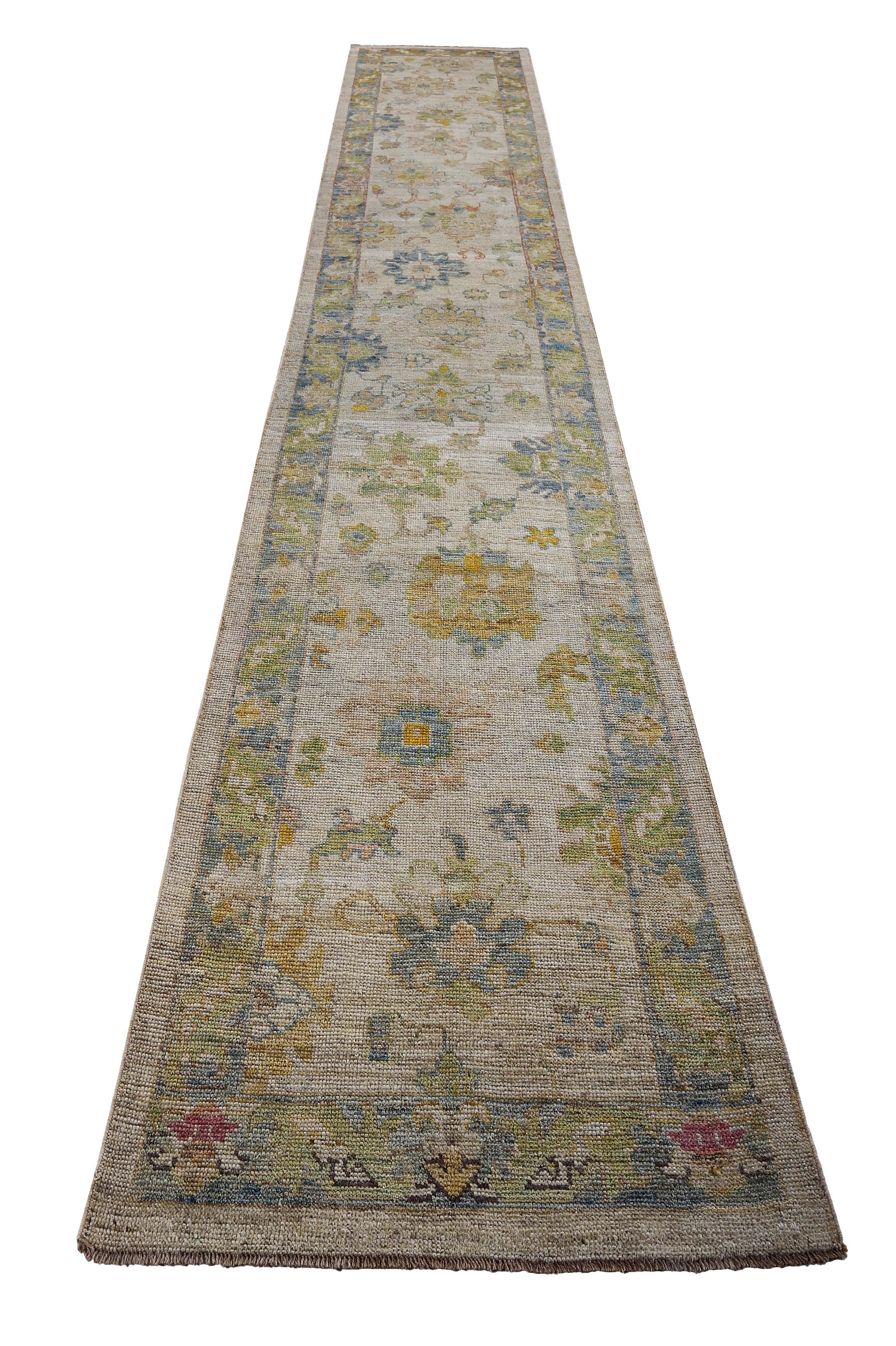 Turkish runner rug made of handwoven sheep’s wool of the finest quality. It’s colored with organic vegetable dyes that are certified safe for humans and pets alike. It features blue and green floral patterns on a beautiful ivory field. Flower