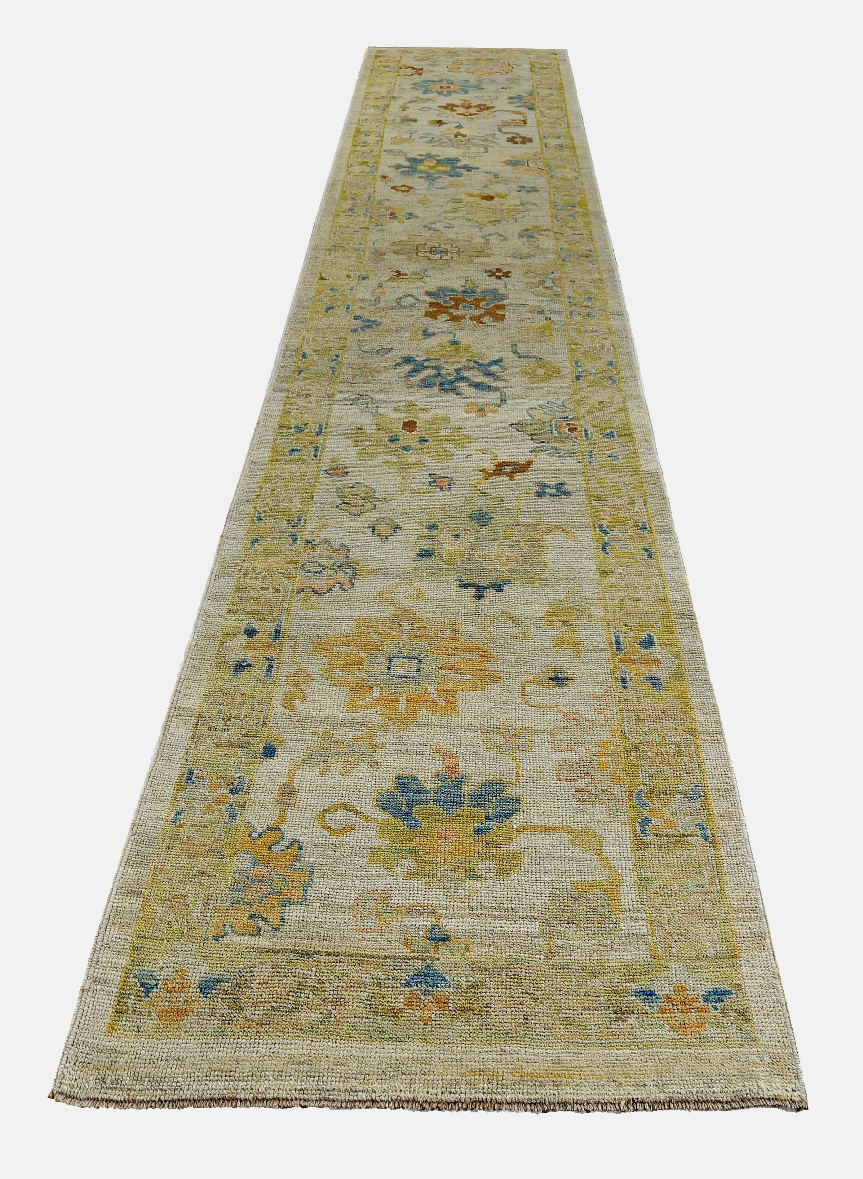 Turkish runner rug made of handwoven sheep’s wool of the finest quality. It’s colored with organic vegetable dyes that are certified safe for humans and pets alike. It features green and blue floral details on a lovely ivory field. Flower patterns