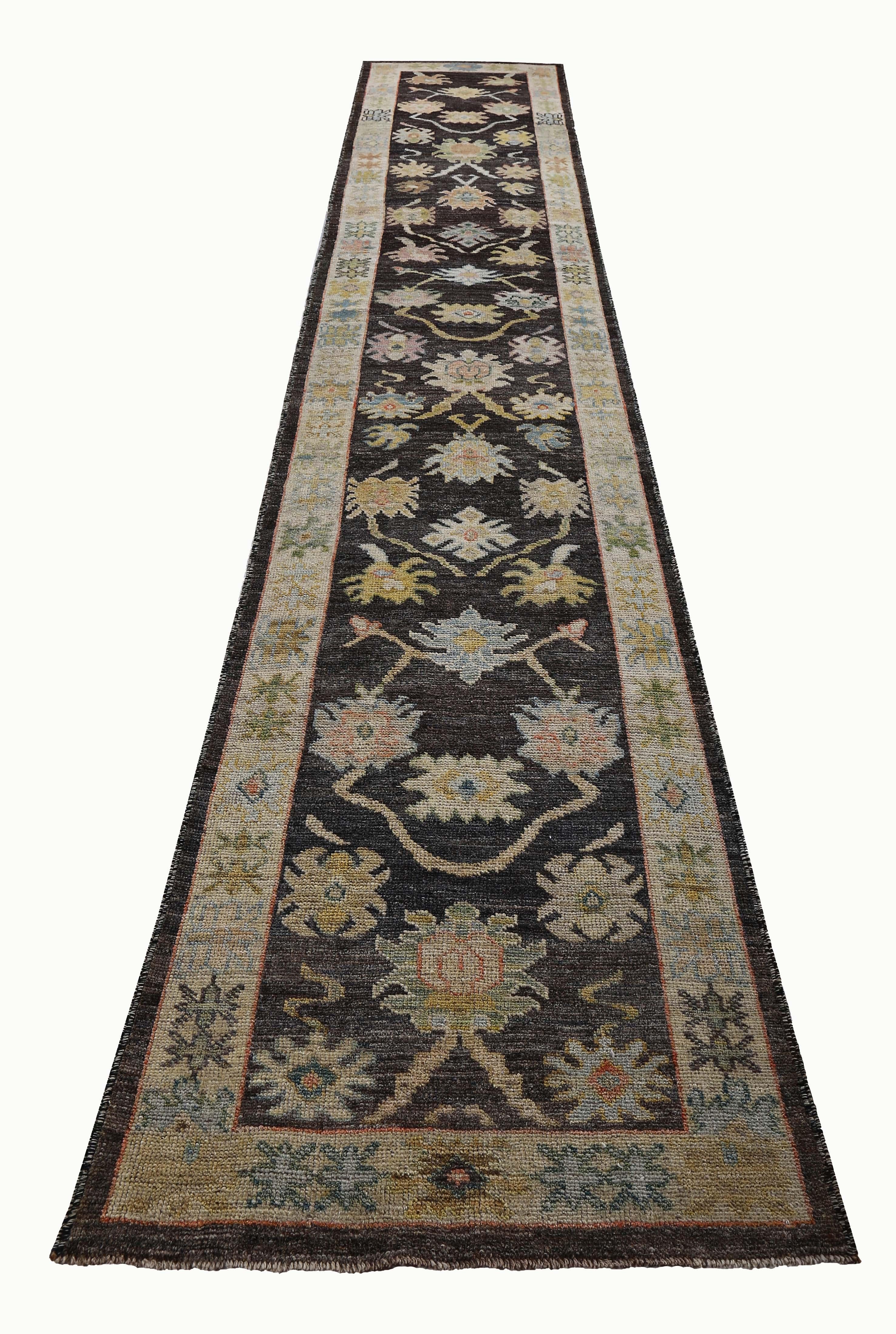 Turkish runner rug made of handwoven sheep’s wool of the finest quality. It’s colored with organic vegetable dyes that are certified safe for humans and pets alike. It features colorful flower heads on a mixed brown and ivory field. Flower patterns
