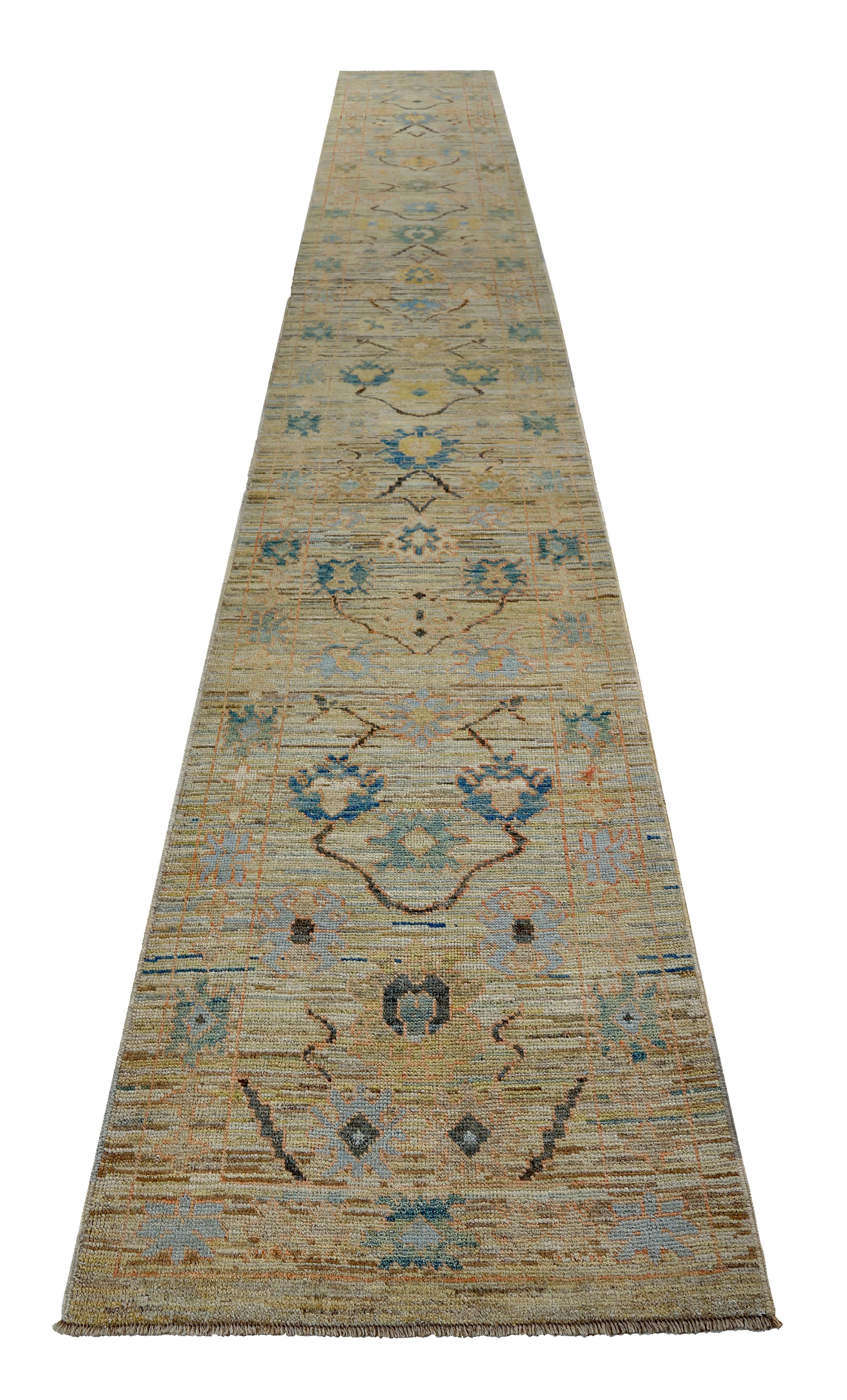Turkish runner rug made of handwoven sheep’s wool of the finest quality. It’s colored with organic vegetable dyes that are certified safe for humans and pets alike. It features green and blue floral details on a lovely ivory field. Flower patterns