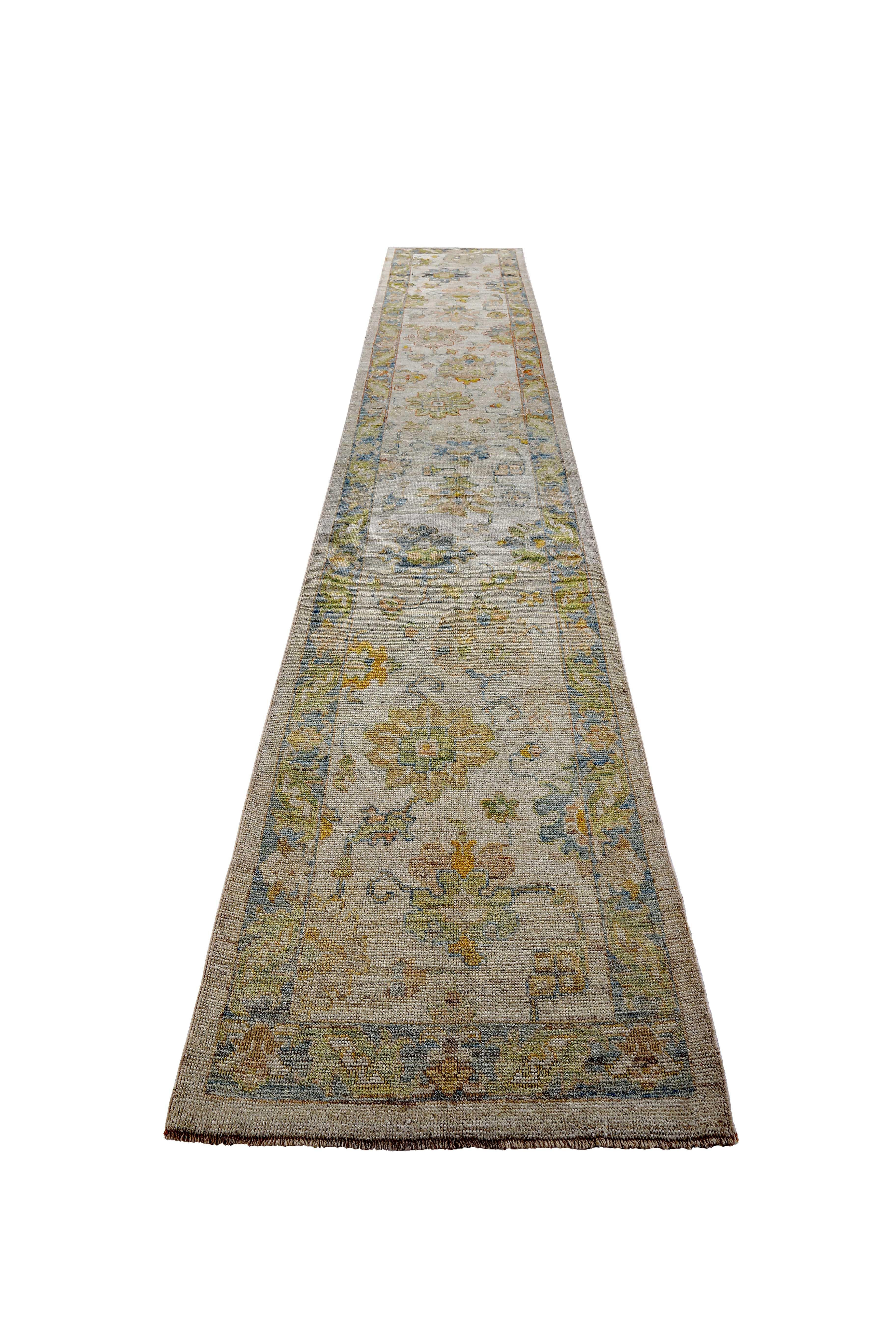 New Turkish rug made of handwoven sheep’s wool of the finest quality. It’s colored with organic vegetable dyes that are certified safe for humans and pets alike. It features navy and green floral details on a lovely ivory field. Flower patterns are
