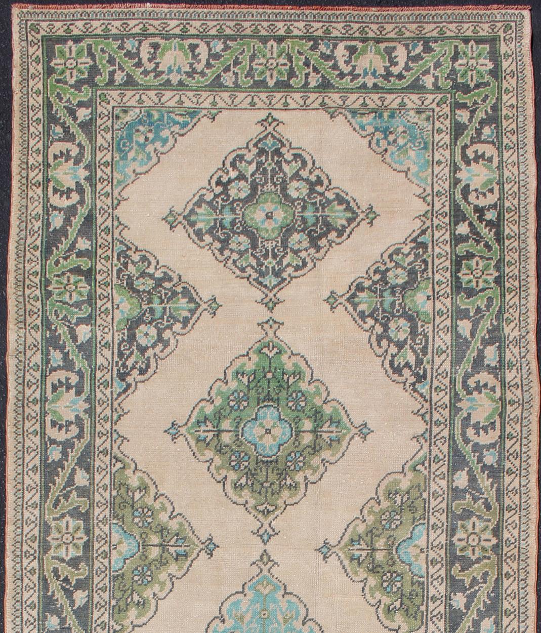 Hand-Knotted Turkish Oushak Runner with Medallion Design in Dark Blue, Blush, Aqua and Green For Sale