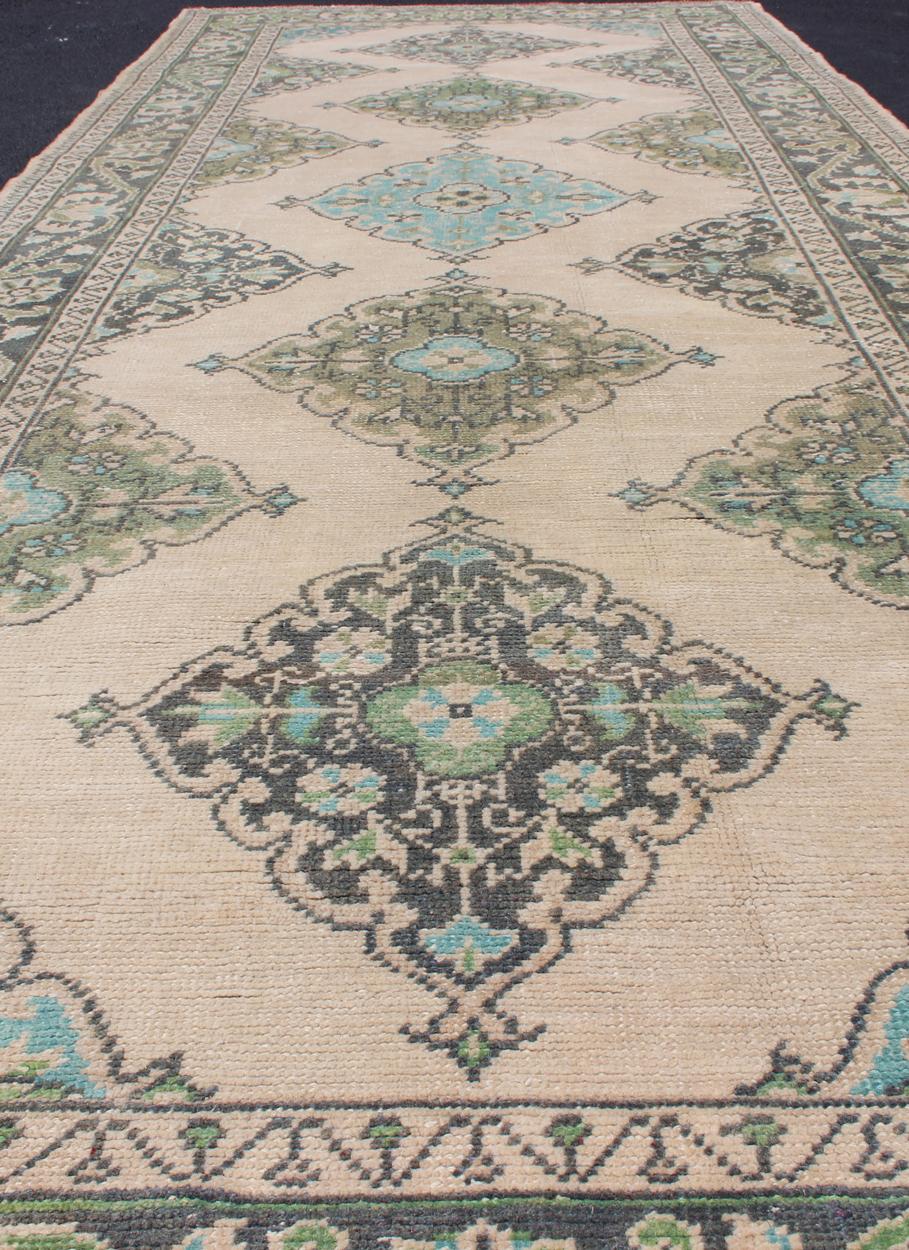 Mid-20th Century Turkish Oushak Runner with Medallion Design in Dark Blue, Blush, Aqua and Green For Sale