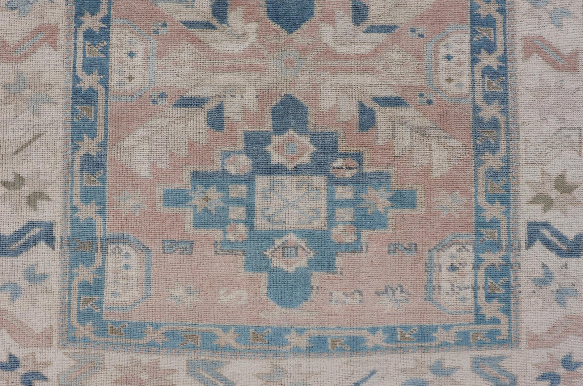 Turkish Oushak Vintage Carpet from Turkey a variety of blue, salmon, beige and natural tones. Rug EN-178331, country of origin / type: Turkey / Oushak, circa 1940

Measures: 4'5 x 6'8 

This vintage Turkish Oushak rug features an intricately