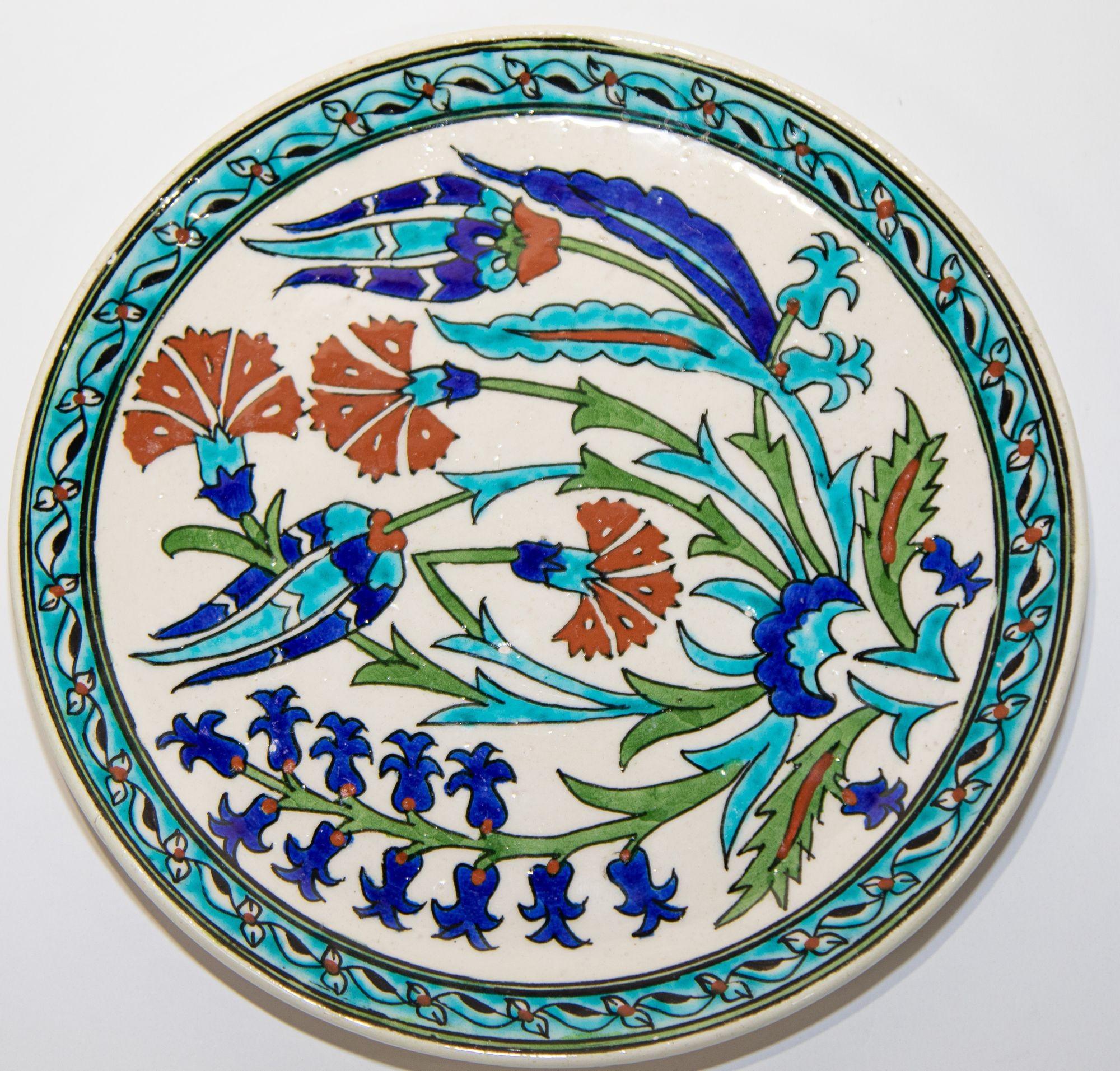 Turkish polychrome hand painted ceramic Kutahya decorative hanging Plate.
Kütahya is famous for its kiln products, such as tiles and pottery, which are glazed and multicolored.
It has a beautifully hand painted flowers in burgundy, turquoise,