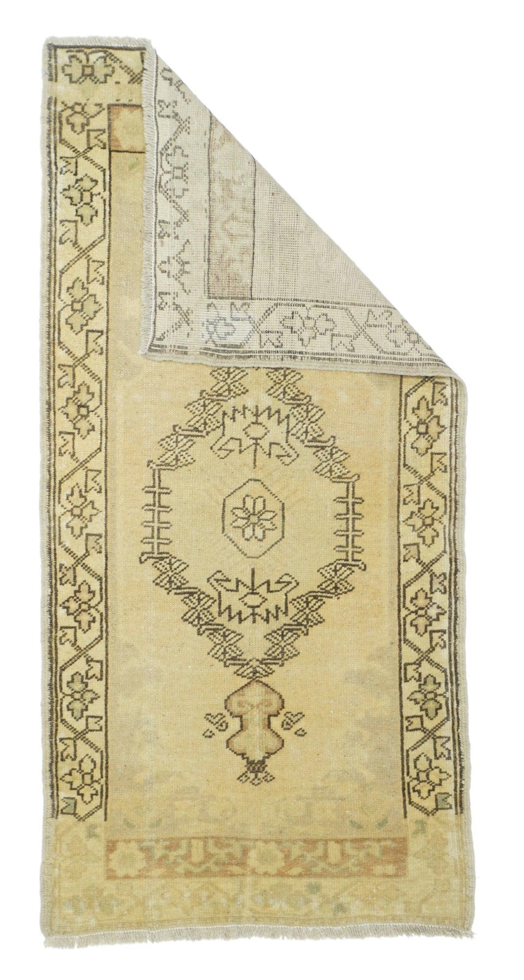 Turkish Rug 2'4'' x 4'9''. The brown border drawing visibly runs around three sides of this long Anatolian rustic scatter and displays a simple trefoil flower and leaf angular meander. The open, outline medallion shows dumbbell pendants and an