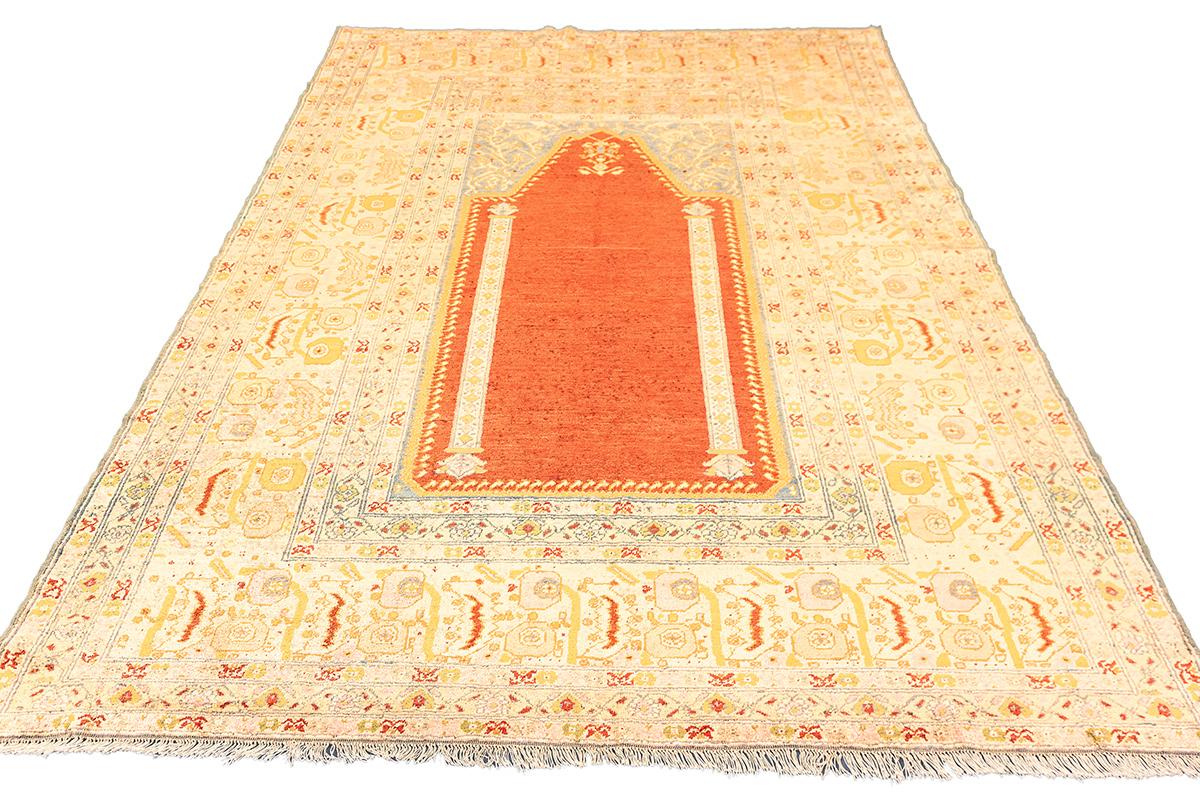 Antique Ghiordes Silk Prayer Rug
This stunning antique Ghiordes silk rug showcases the traditional prayer niche (mihrab) design, a hallmark of Turkish weaving from the town of Ghiordes (Gördes), renowned for its exceptional craftsmanship and sacred