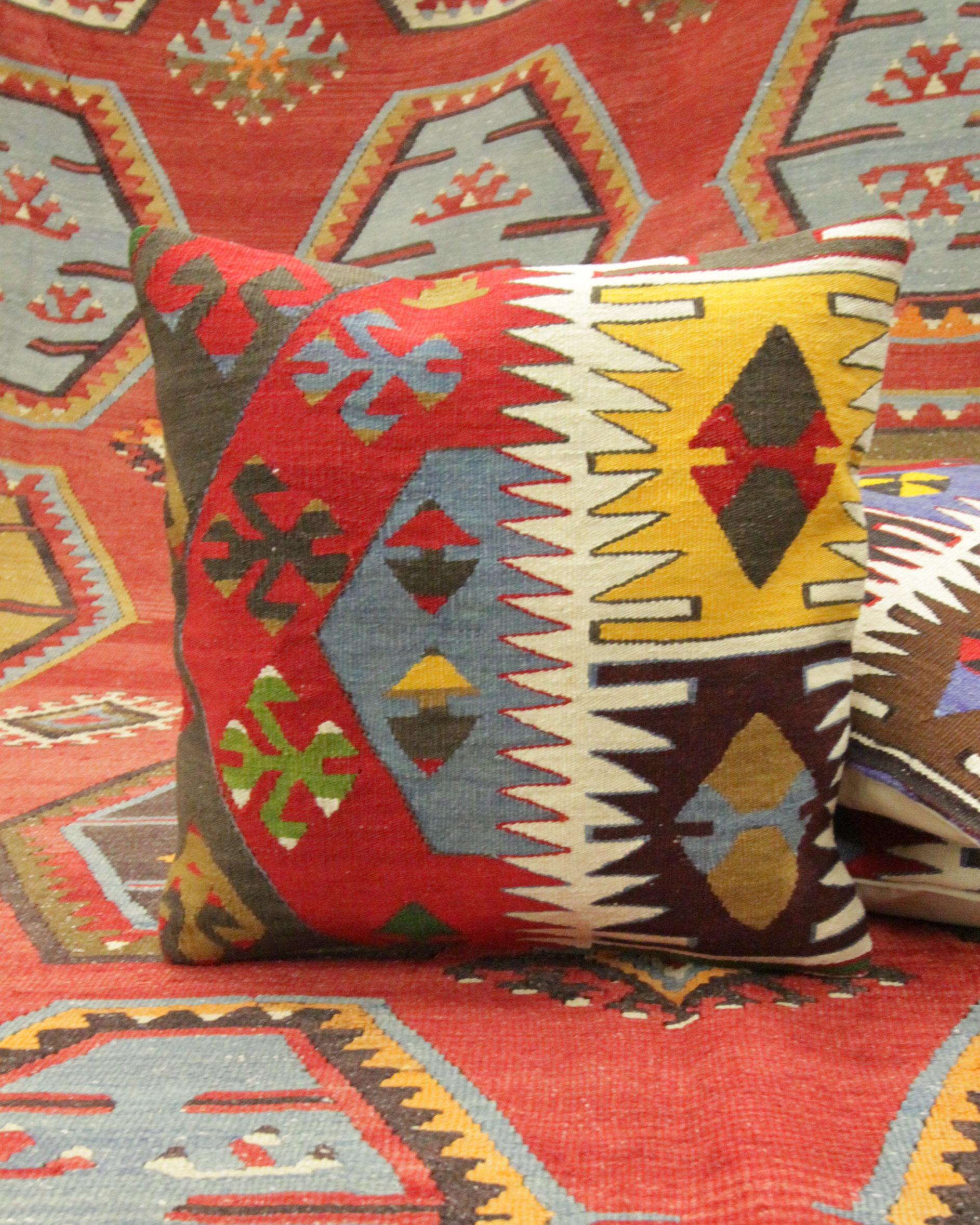 This unique geometric cushion cover is a modern handwoven Turkish Kilim cushion cover. The design features traditional geometric designs woven in blue, red, cream and green. The traditional design and bold primary colours featured in this scatter