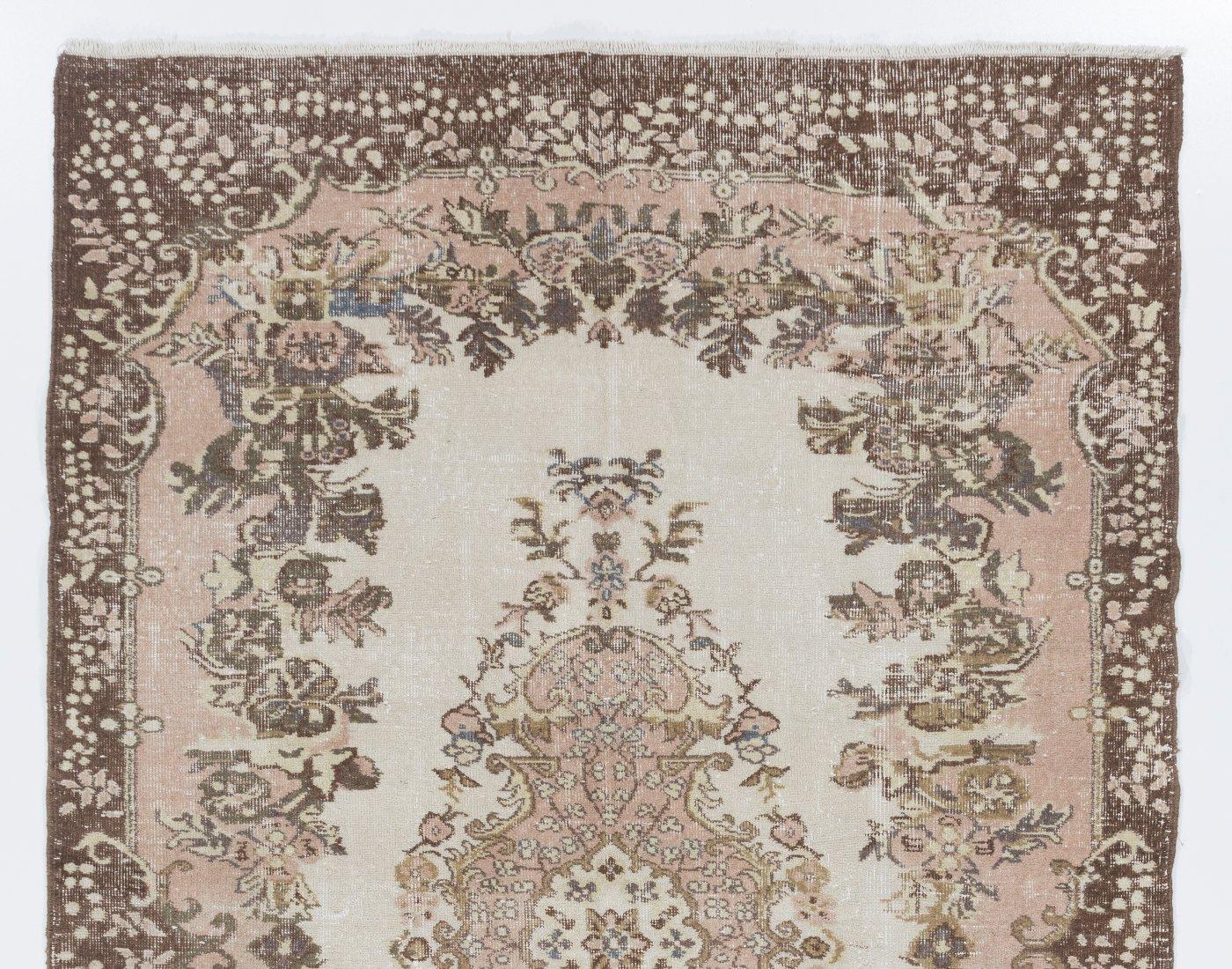 A hand-knotted vintage Turkish accent rug. The rug features a floral medallion design in a field decorated with floral motifs. It has low distressed wool pile on cotton foundation, is in very good condition, sturdy and clean as a brand new rug.