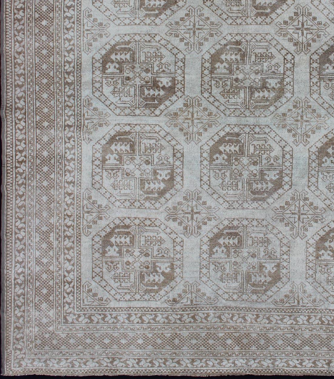 Square shape Antique Turkish rug with Medallion and geometric Solar/Ersari design, rug EN-293, country of origin / type: Turkey / Tribal, circa 1920

Set on a neutral gray-toned background, this tribal design piece features repeating medallions in