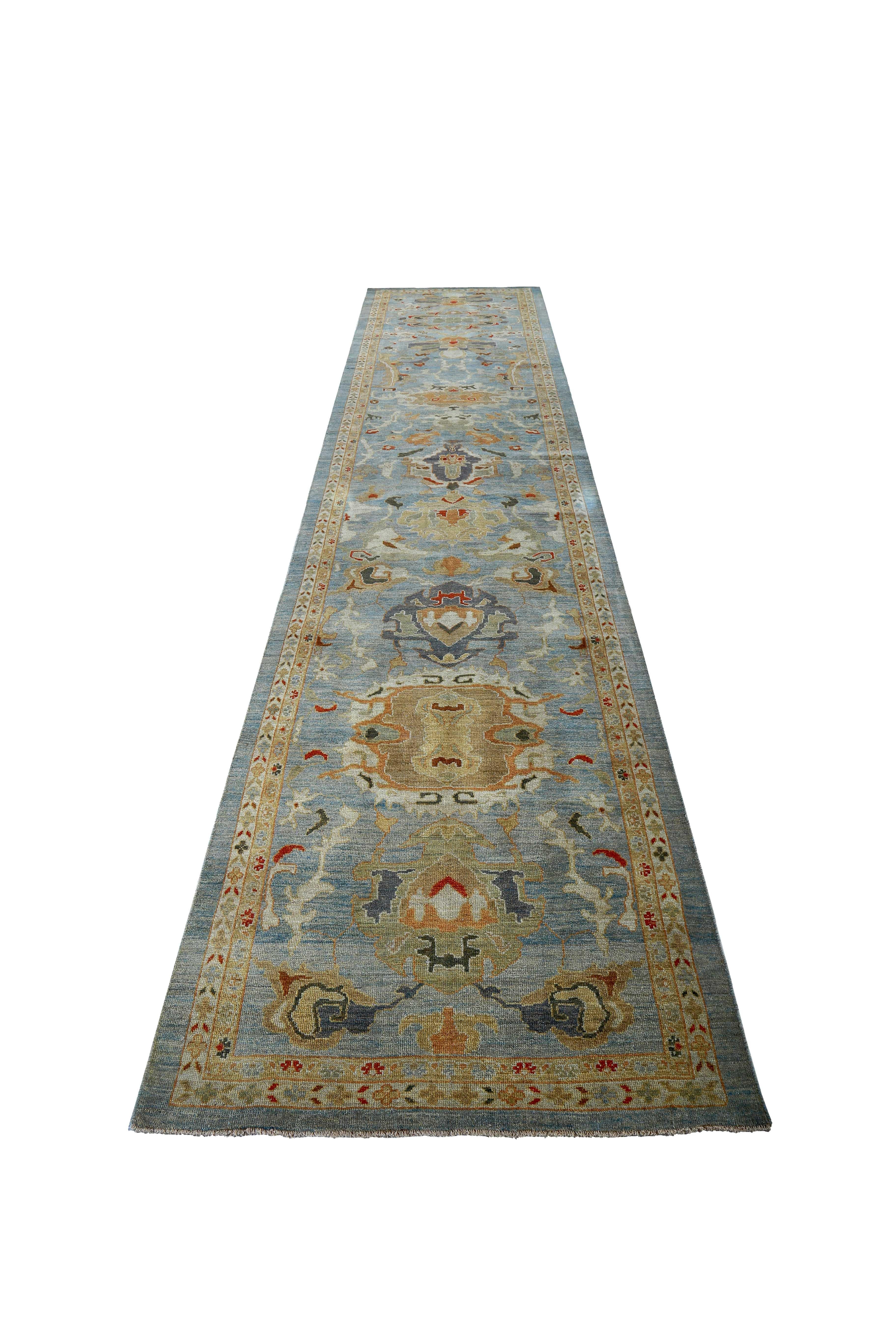 New handmade Turkish runner rug from high quality sheep’s wool and colored with eco-friendly vegetable dyes that are proven safe for humans and pets alike. It’s a classic Sultanabad design showcasing a lovely blue field with prominent Herati flower
