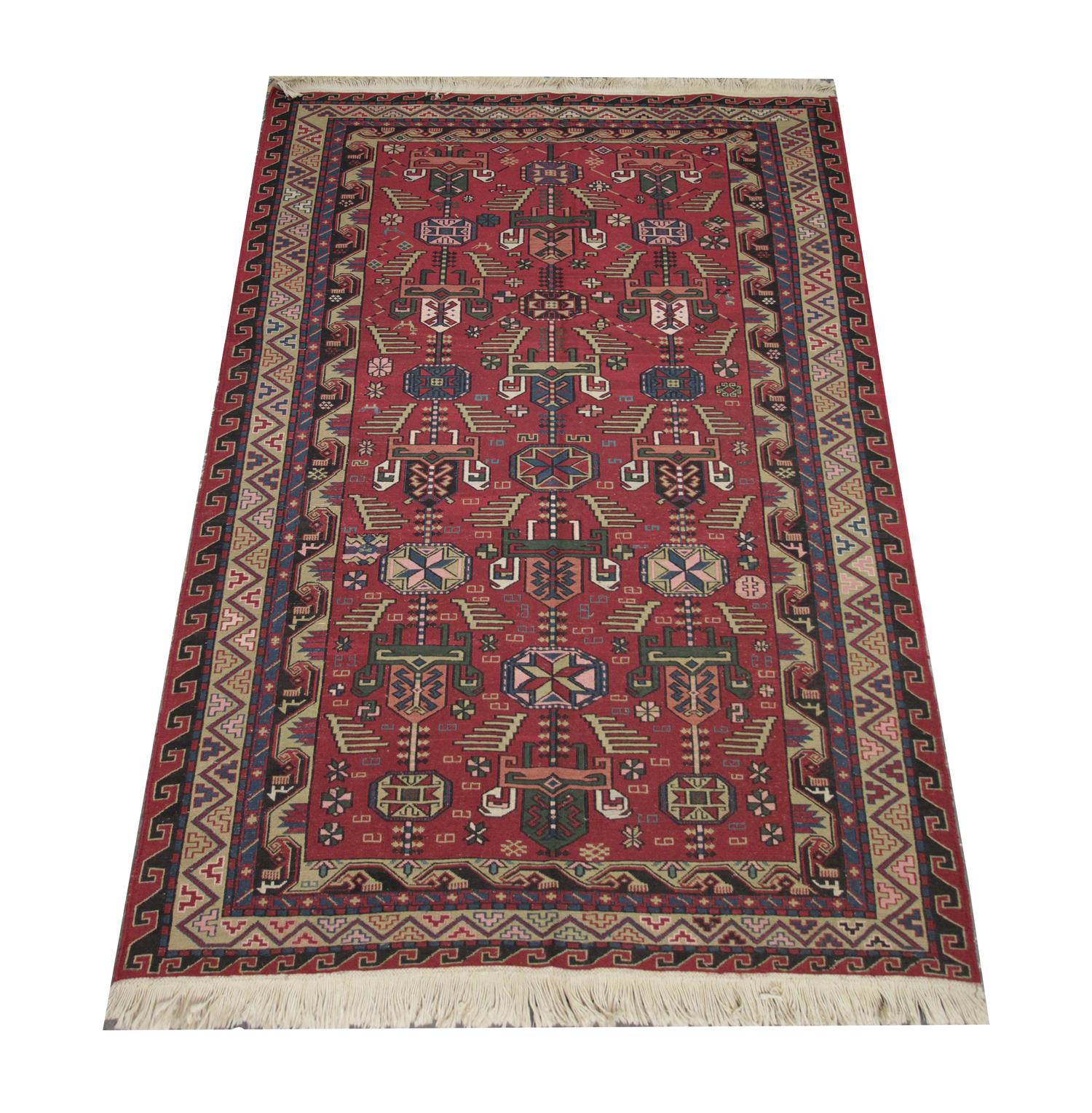 This fine wool tribal Soumak rug is rich in both colour and design. Woven with a rich red background with green, beige, cream and blue accent colours that make up the tribal motifs. A bold repeating pattern border then frames this. This