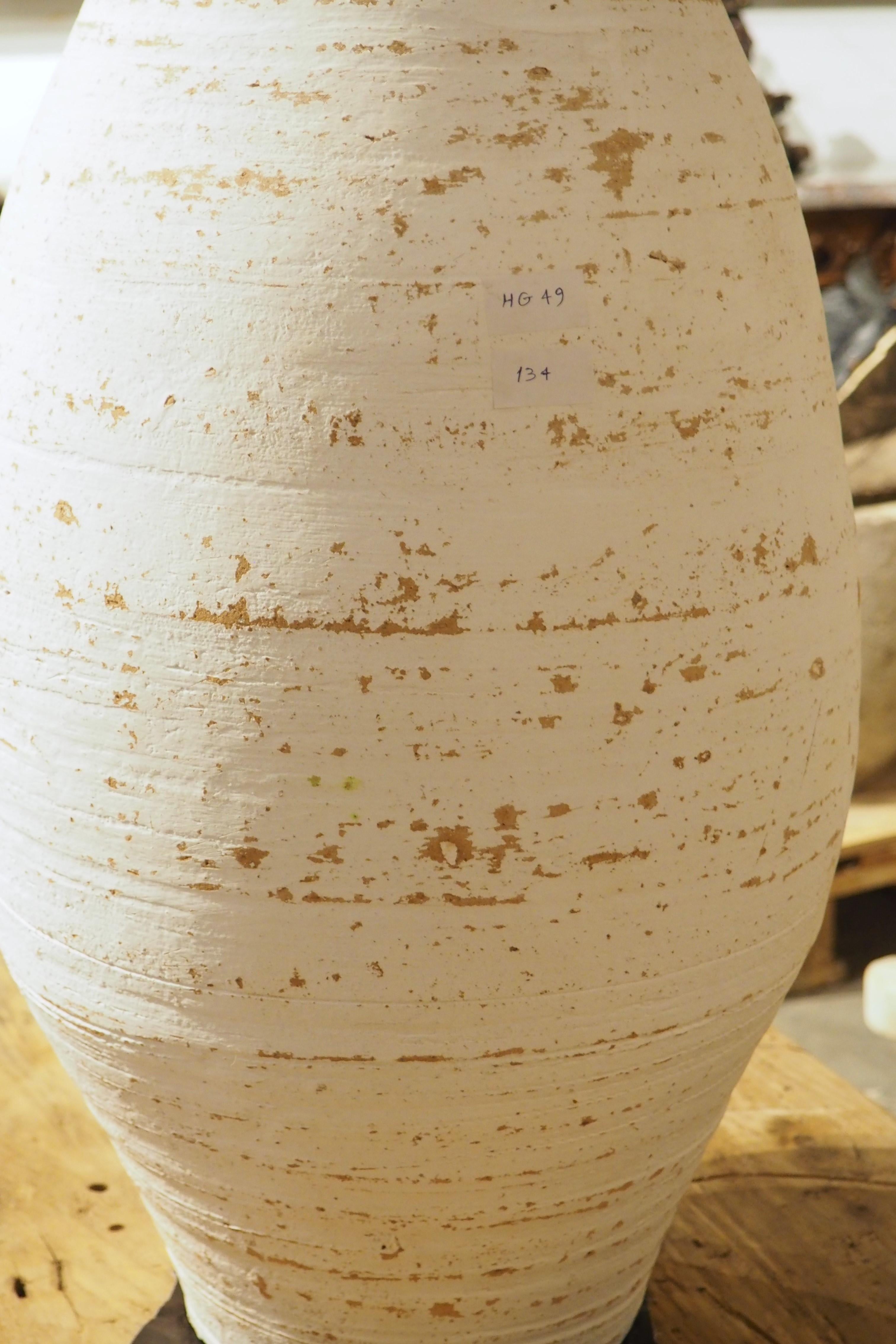 Often found in the Mediterranean areas of Southern Europe, Northern Africa, and Western Asia, olive pots have been used for centuries to store grains and oils for cooking. This particular tall, slender terra cotta pot is a contemporary offering from
