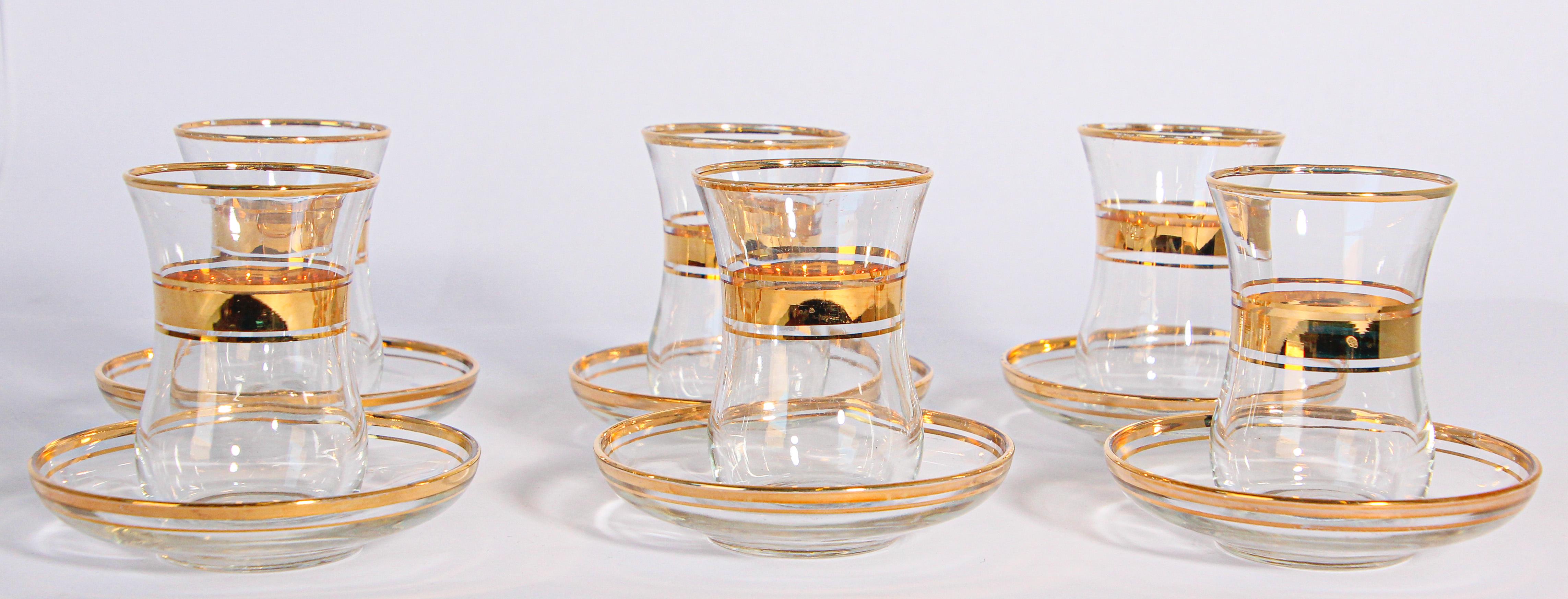 Set of six Turkish tea glasses with gold raised overlay design.
Set of blown glass after dinner cup and saucers featuring raised paste gilt designs.
The shape of the saucers could also be used separately as a small side or sauce dish.
Six cup and