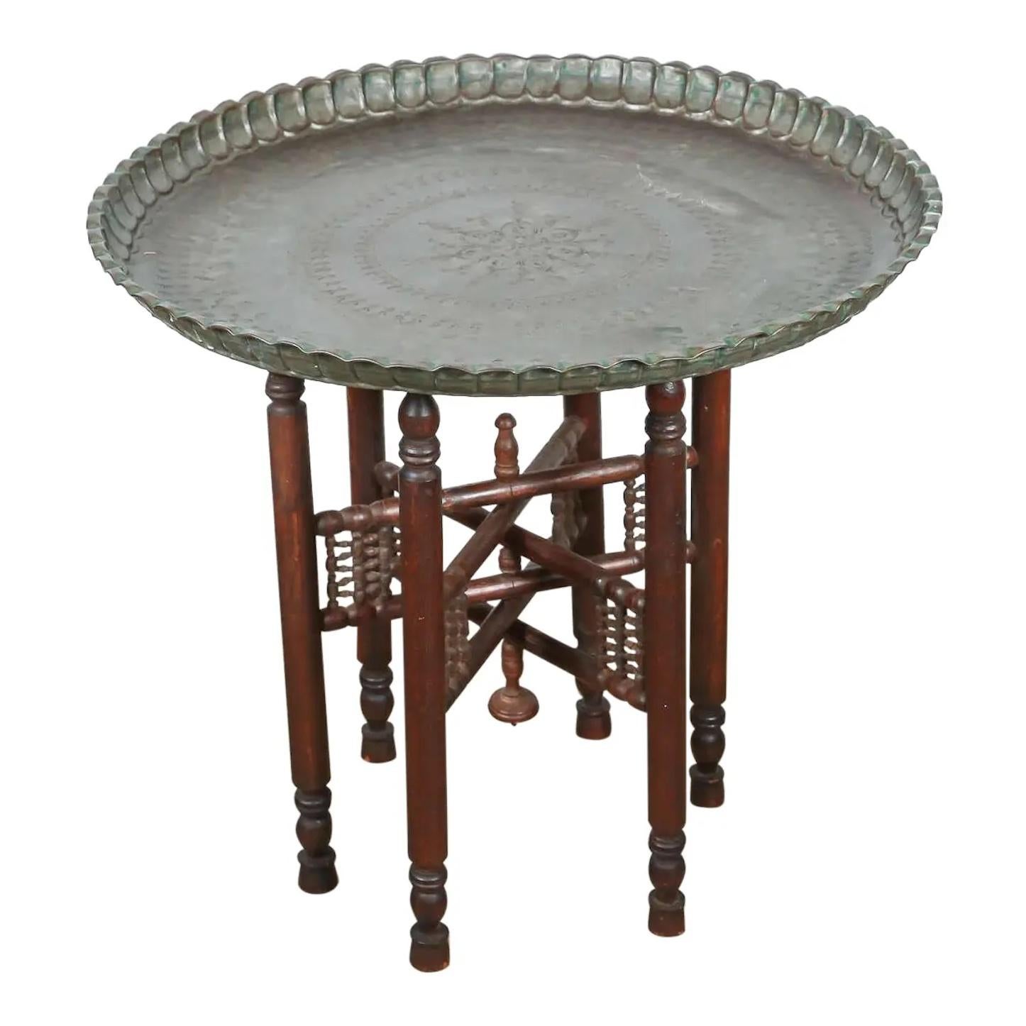 Turkish tin copper tray table on wooden folding stand 
Turkish Persian Mameluke style tinned copper tray table. 
Very nice unusual Asian dark bronzed color tray on folding wooden stand nicely carved with musharabie fret work. 
The tinned copper