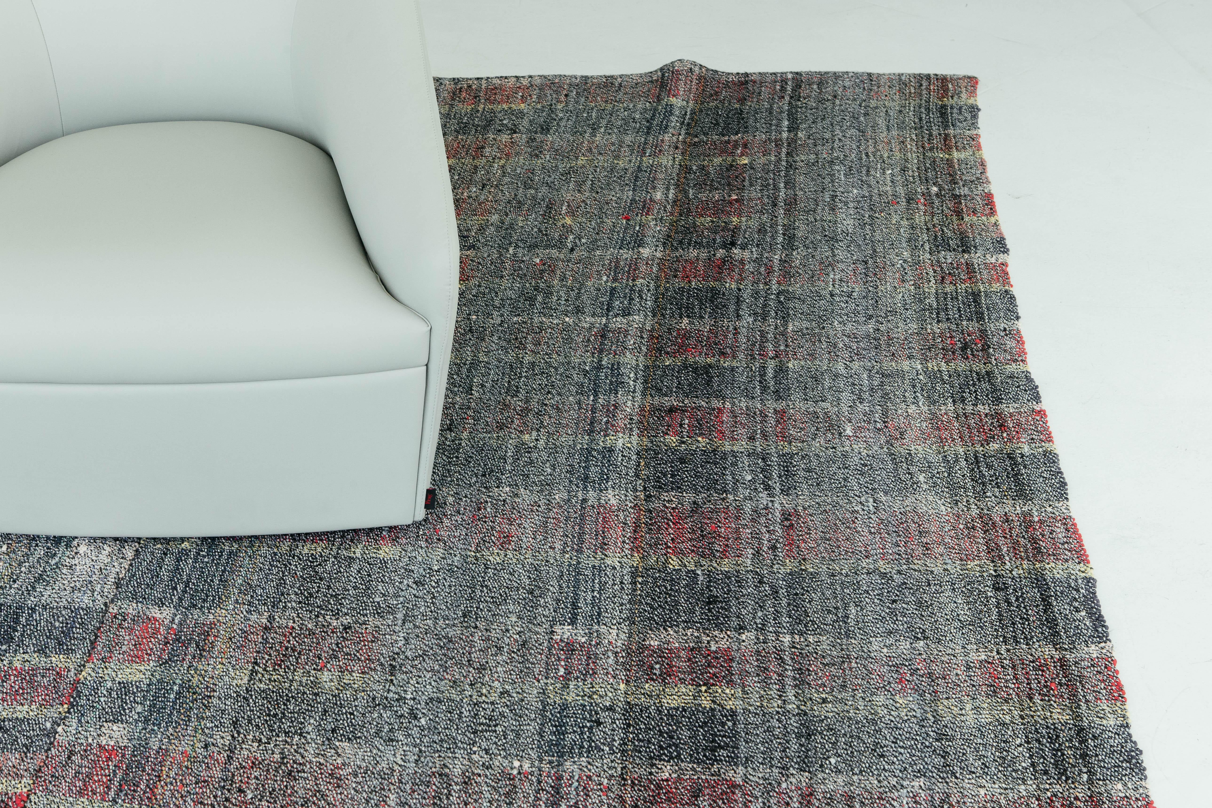 This Turkish Tisse Kilim weaves together beautiful colors to create an irregular plaid pattern. Mauve, forest green, and yellow are just some of the many colors that create a cohesive look in an interesting texture. This flat-weave would be a great