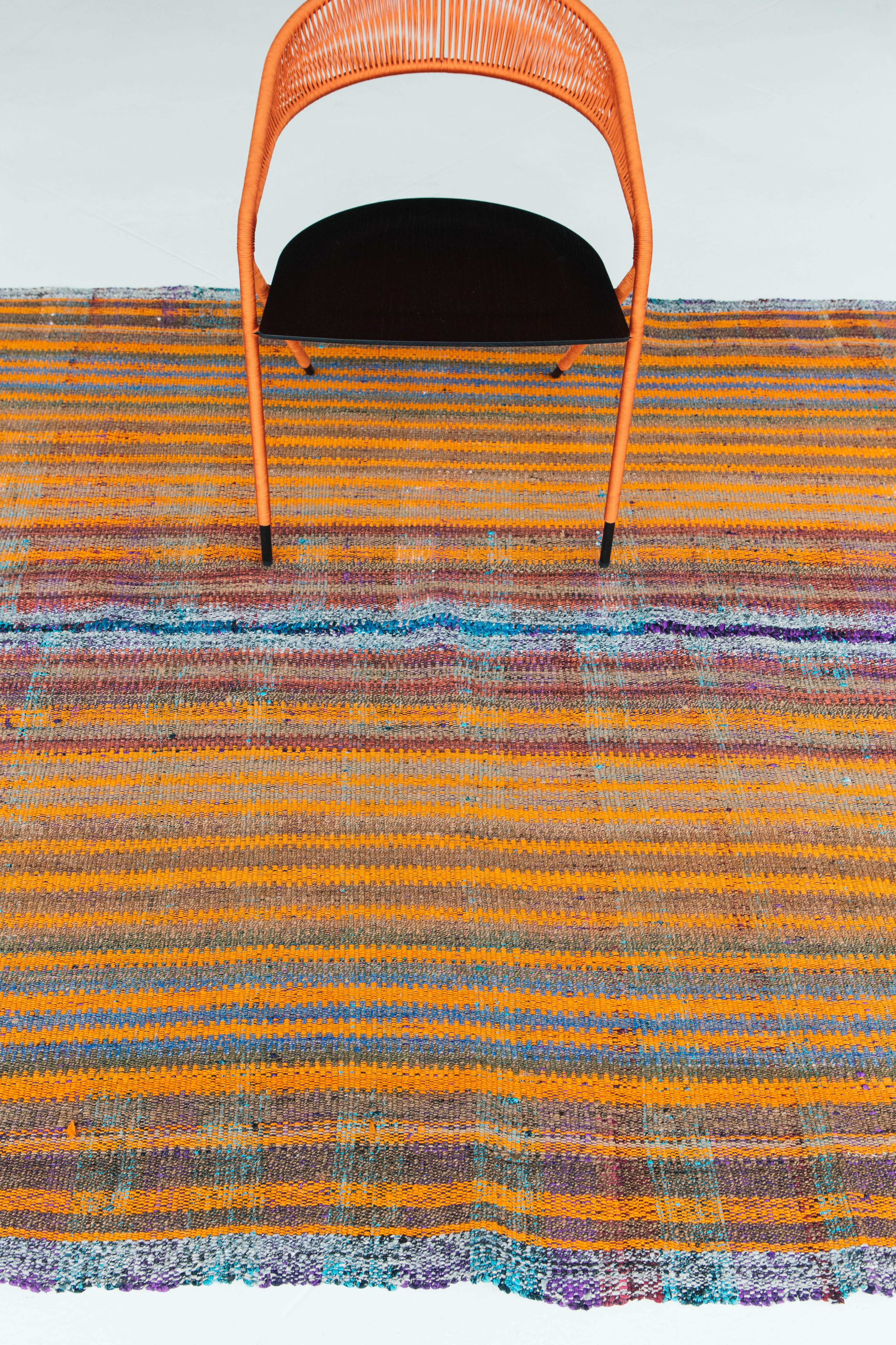 This Turkish Tisse Kilim weaves together beautiful colors to create an organic stripe pattern. Bright orange, purples and hues of red are just some of the many colors that create a cohesive look in an interesting texture. This flat-weave would be a