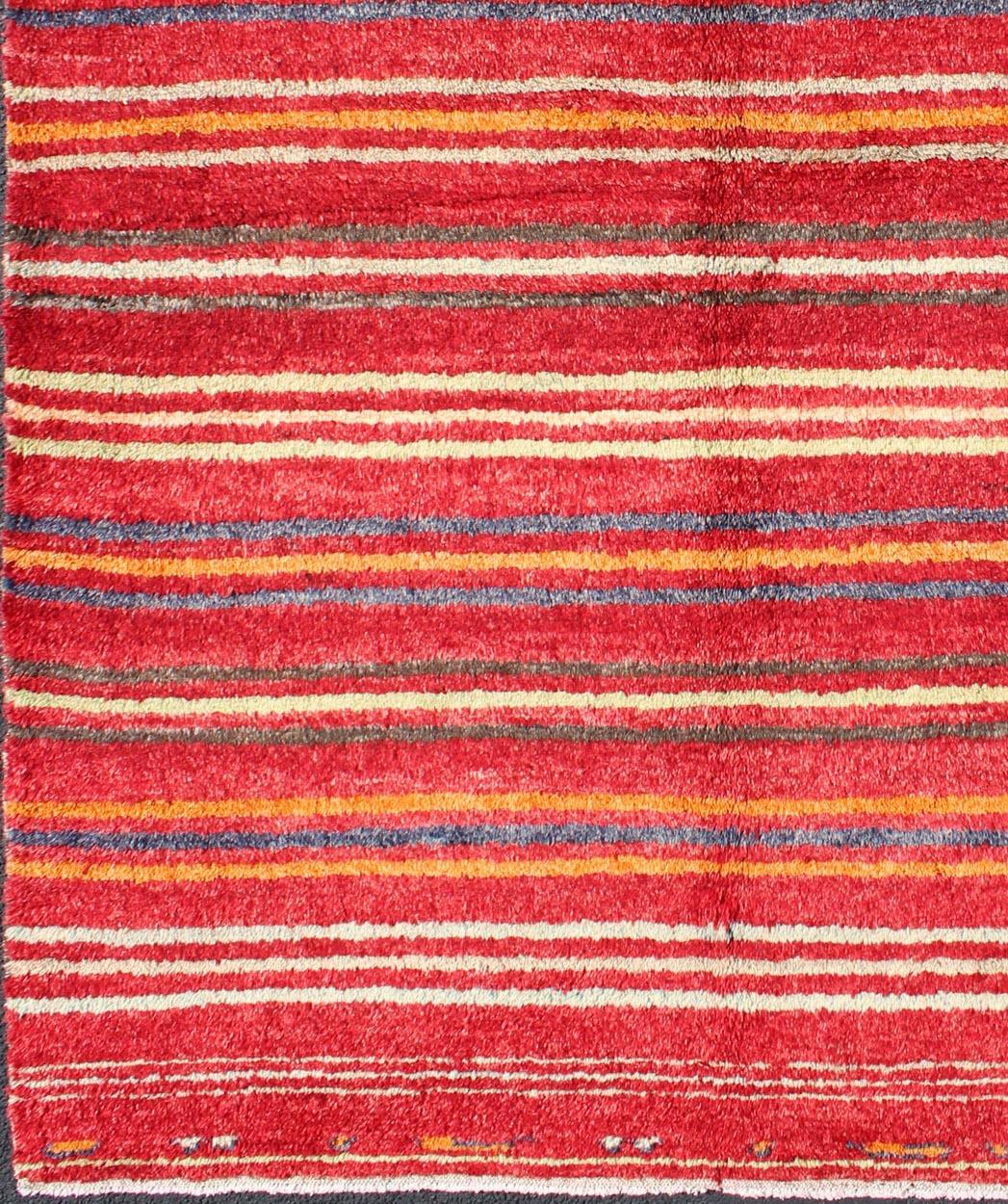 Striped Colored Tulu Carpet from Turkey in Blue, Green and Orange
rug/en-3271 Keivan Woven Arts / origin/turkey / mid-20th Century

This charming high-pile Tulu rug is handwoven from wool in a soft and colorful palette, featuring a striped pattern