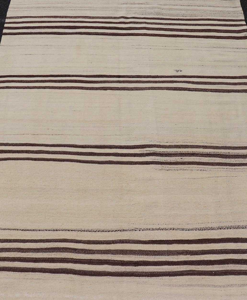 Turkish Vintage Flat-Weave in Brown and Cream with Stripe Design. Keivan Woven Arts / rug EN-14904, country of origin / type: Turkey / Kilim, circa 1950
Measures: 4'11 x 6'4 
This vintage striped design Turkish Kilim rendered in shade of browns, and