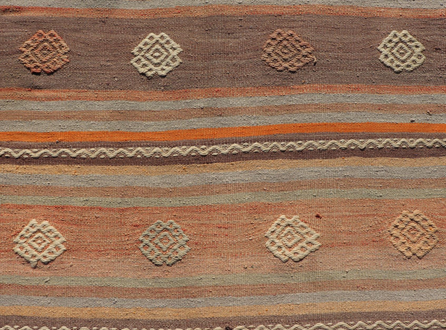 Measures: 3'4 x 11'3
Turkish Vintage Flat-Weave Kilim in Muted Colors with Stripes and Embroideries. Keivan Woven Arts: rug TU-NED-5011 / mid 20th century Turkey. 

This charming vintage flat weave Kilim was hand woven in Turkey during the 1950s.