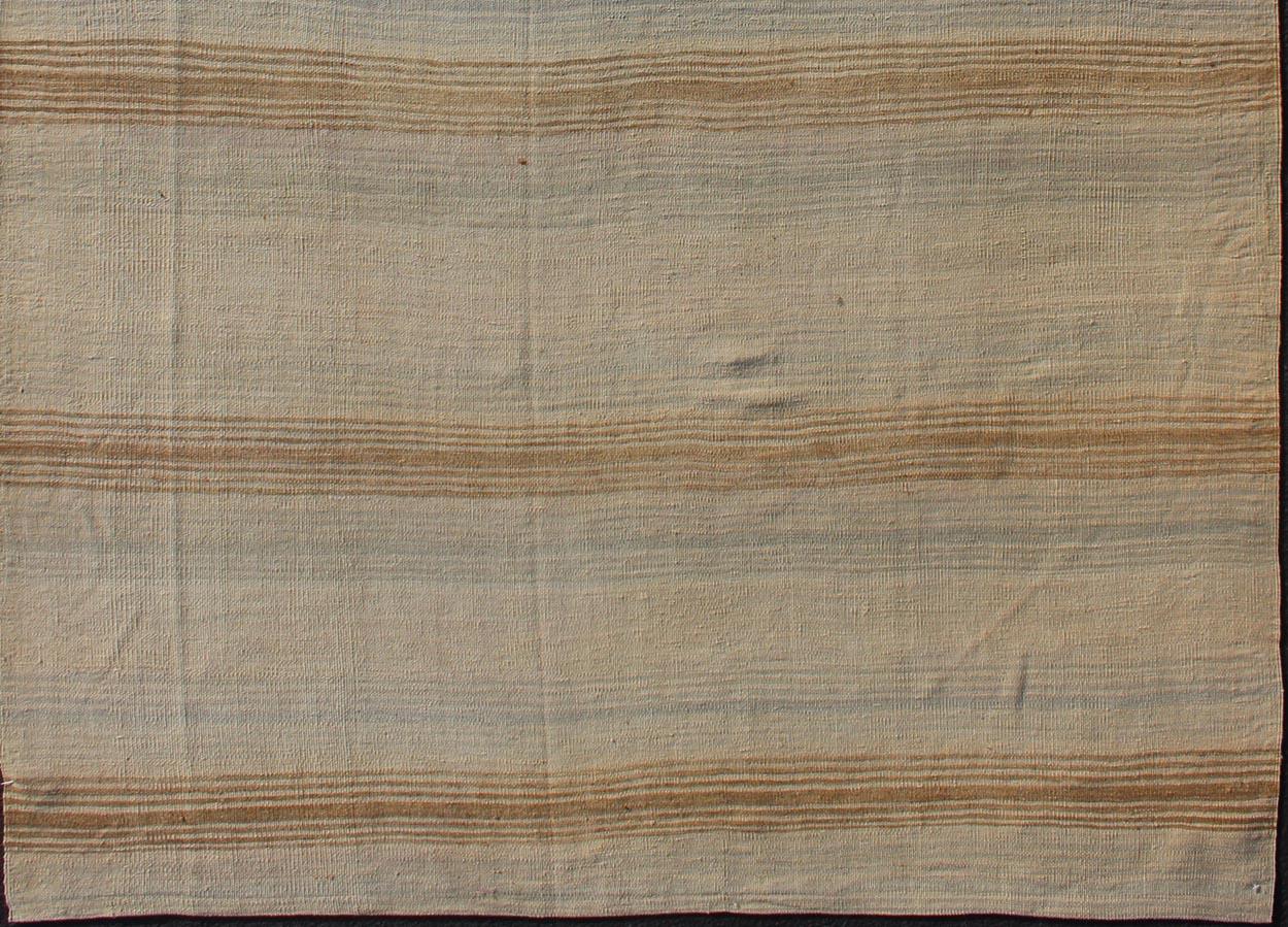 Minimalist stripe design Kilim from Turkey, rug EN-179550, country of origin / type: Turkey / Kilim, circa 1950

This vintage flat-woven Kilim features a minimalist design rendered in stripes, set atop a taupe background with subtle brushes of tan,